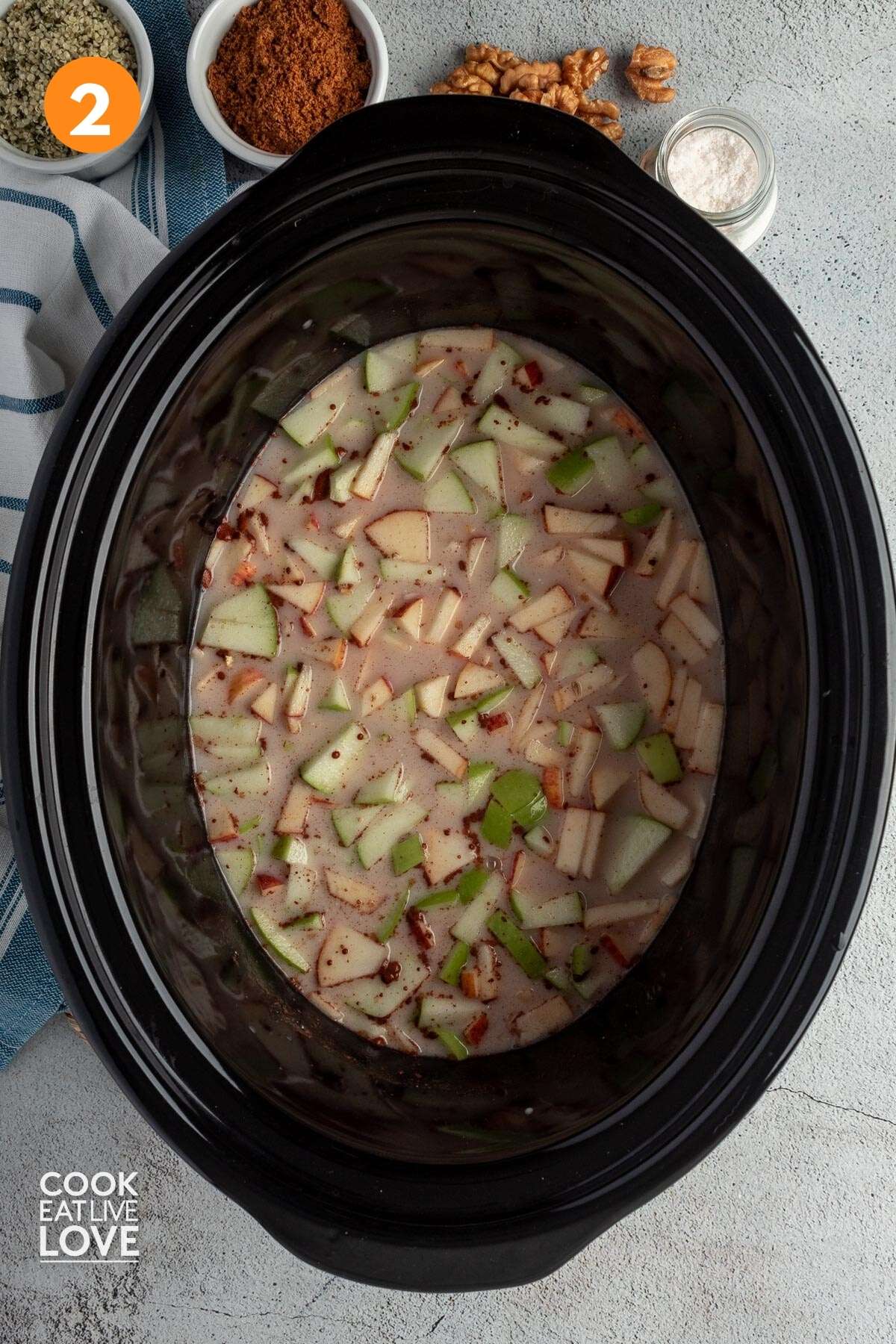 Everything mixed up and ready to cook apple oatmeal in the slow cooker.