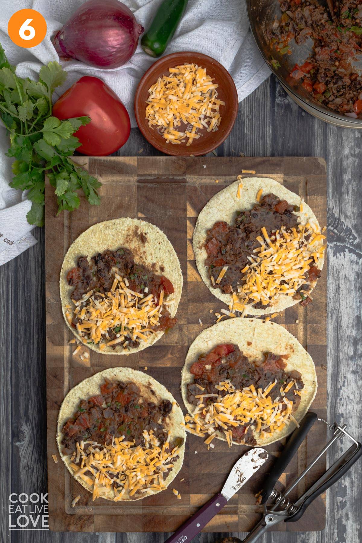 Cheese sprinkled over top of corn tortillas.