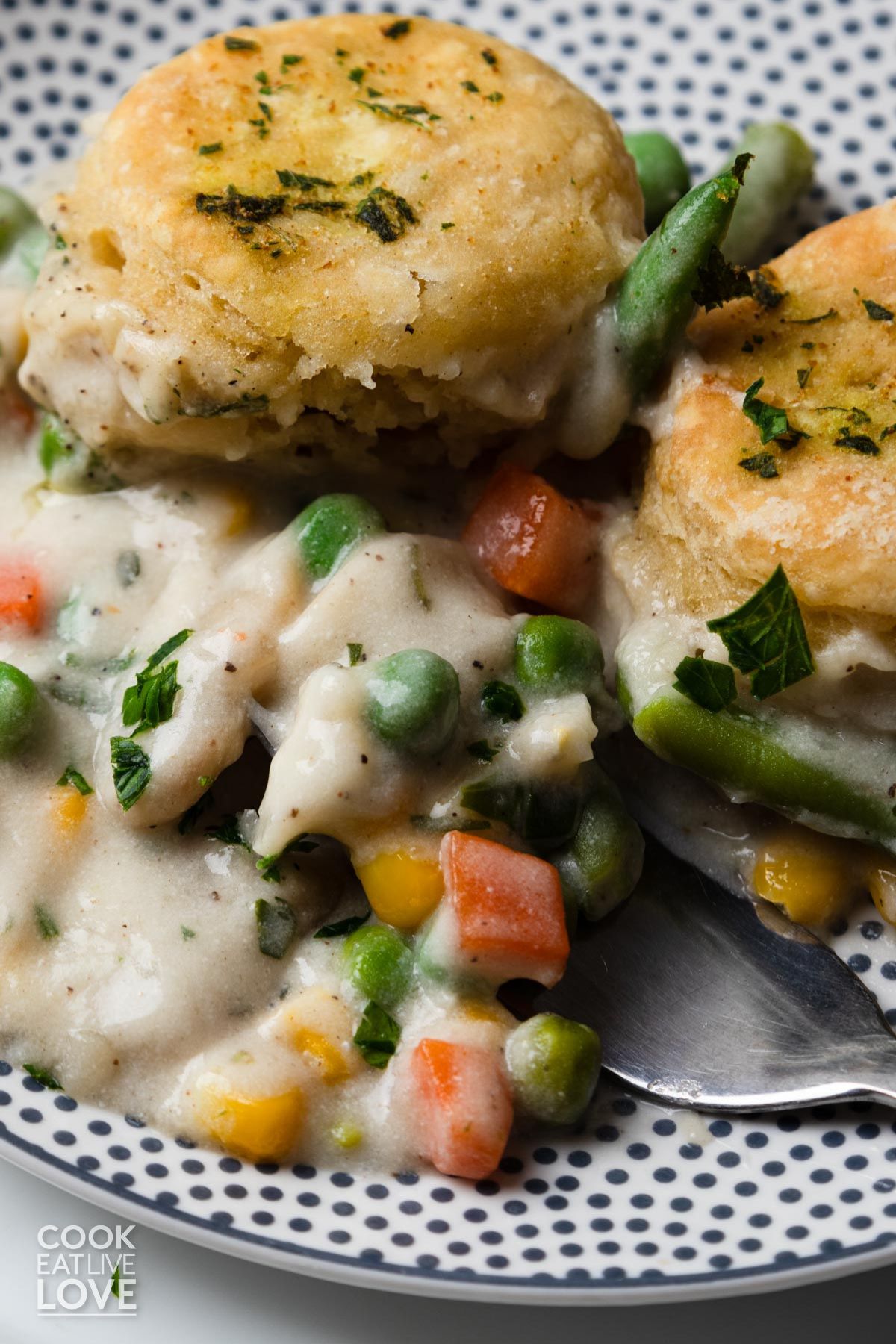 Vegan pot pie served up on a plate with a fork digging in.