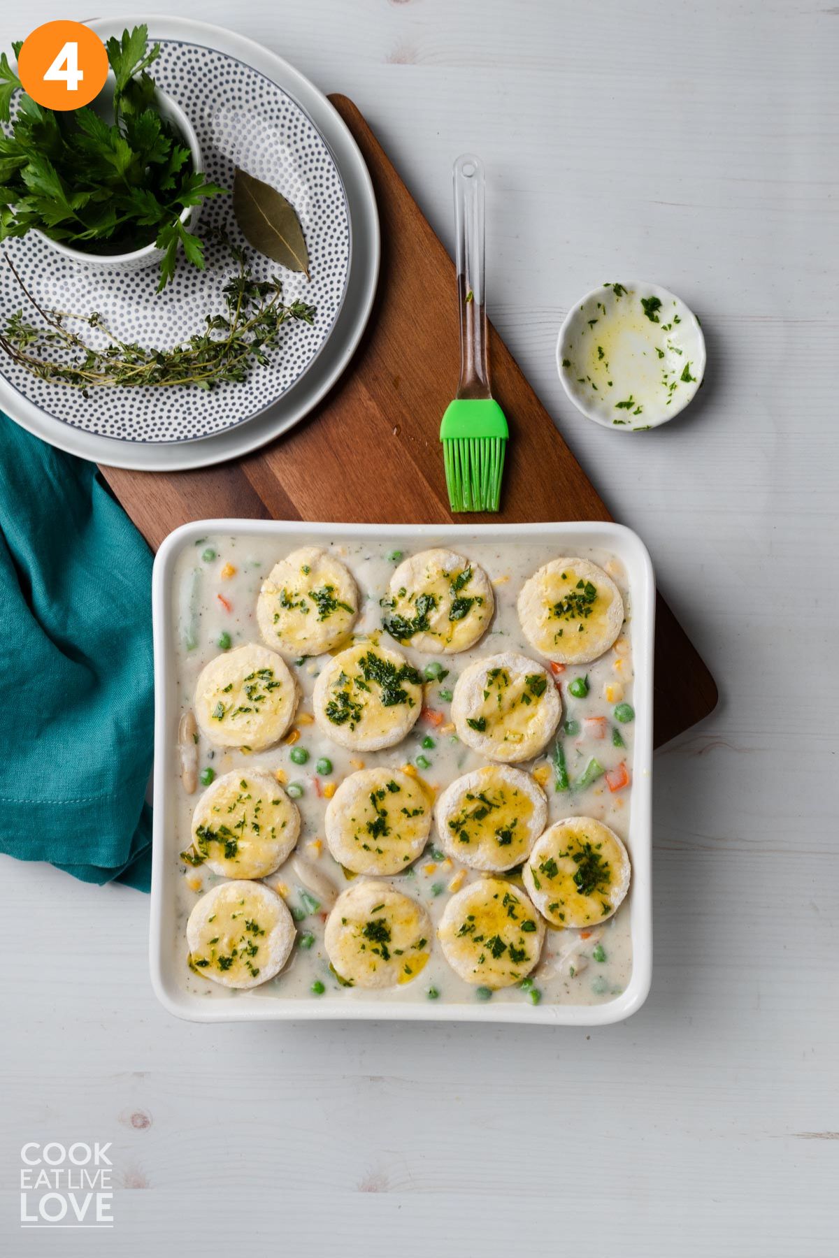 Biscuits added on top and brushed with olive oil and parsley.