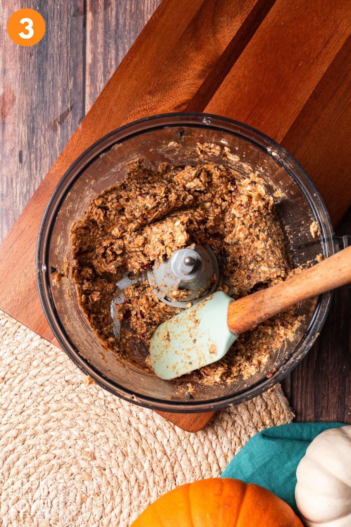 Mixture after processed in the food processor bowl with a spatula in the bowl.