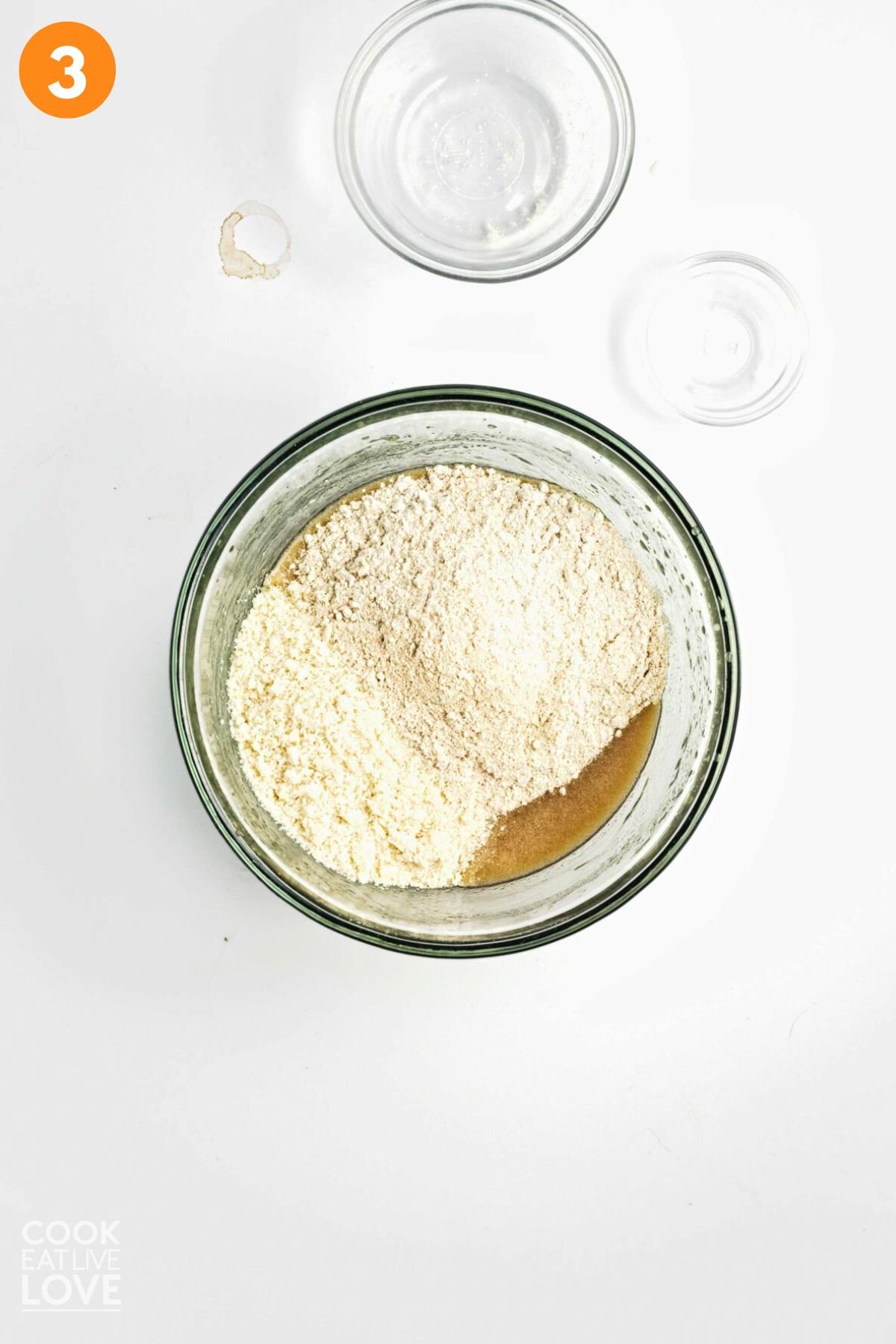 Flour and other dry ingredients added to the bowl.