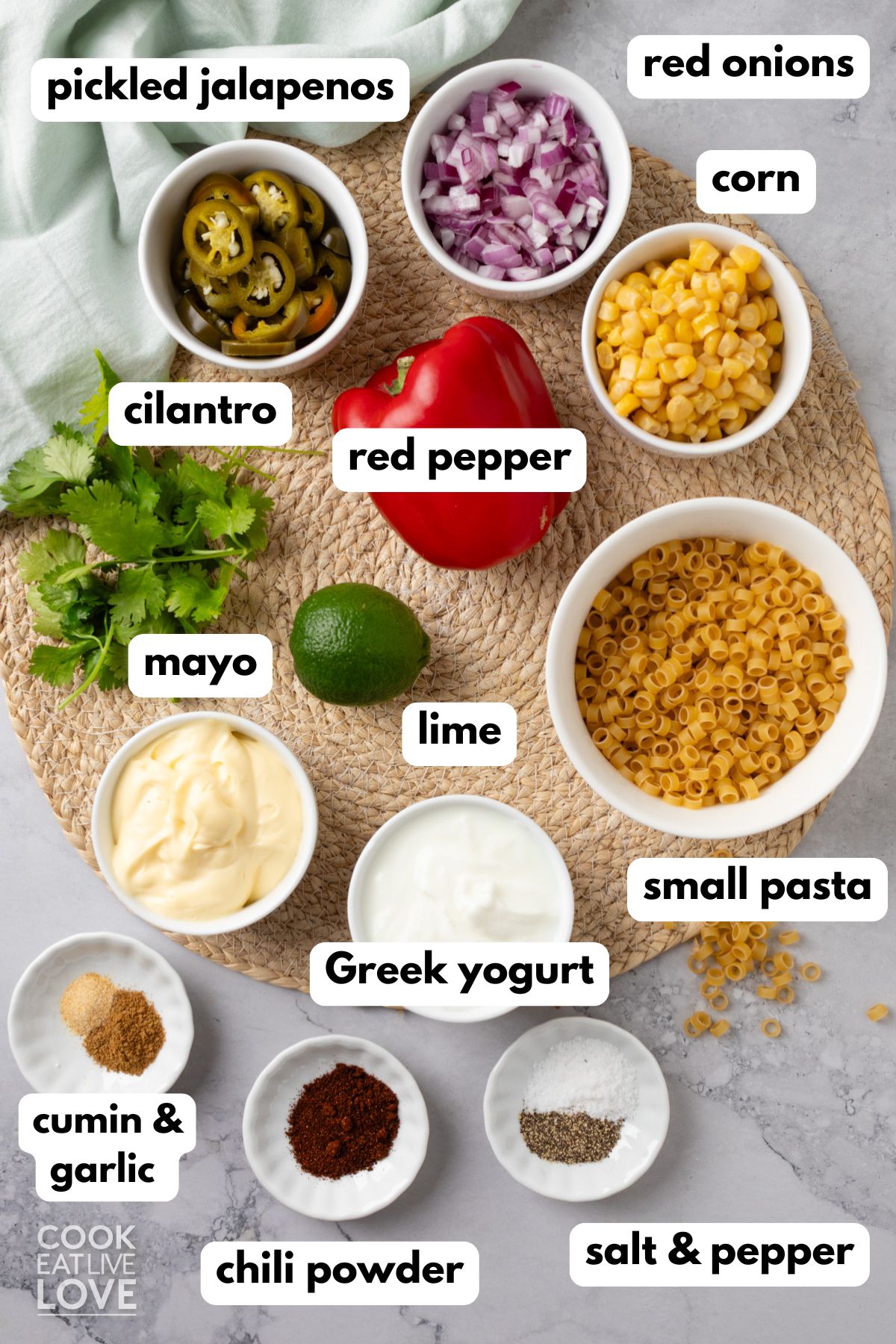 Ingredients to make Mexican macaroni salad in bowls with text labels.