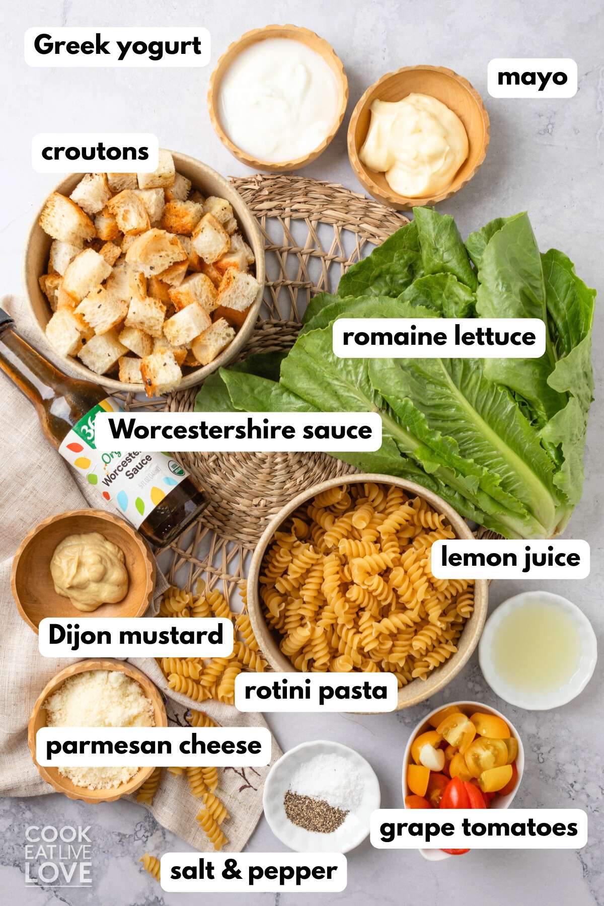 Ingredients to make Caesar pasta salad on the table before mixing. 