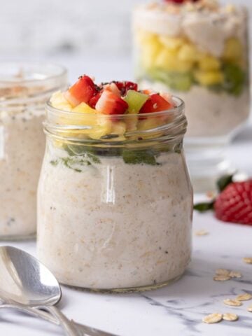A jar of Greek yogurt overnight oats topped with fruit.