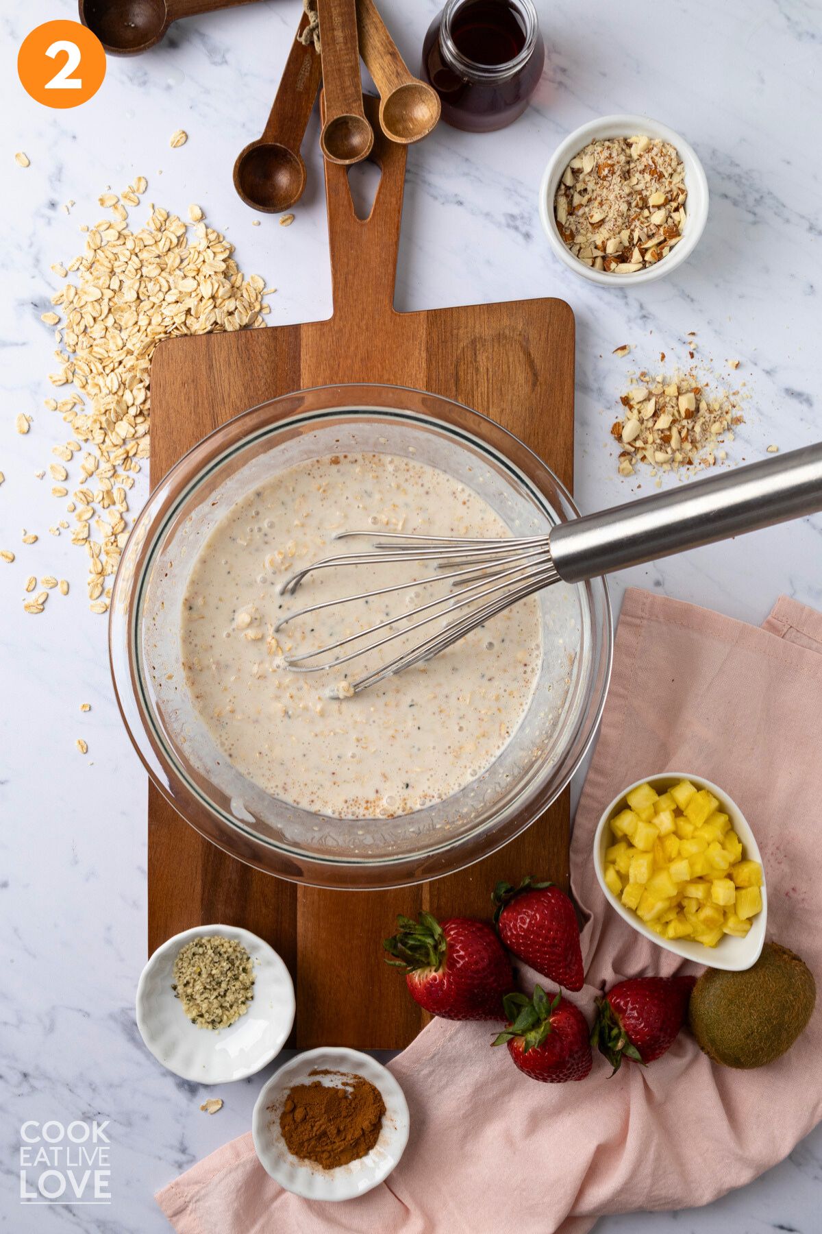 Stirring them together with a whisk.