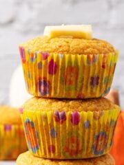 Pumpkin cornbread muffins stacked on top.