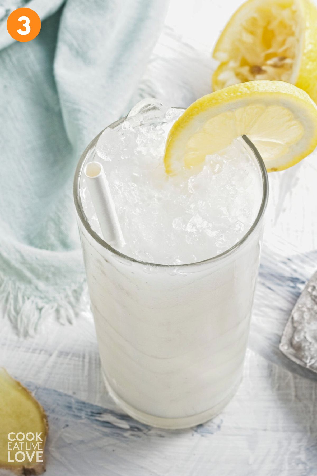 Coconut lemonade poured into a glass with ice.