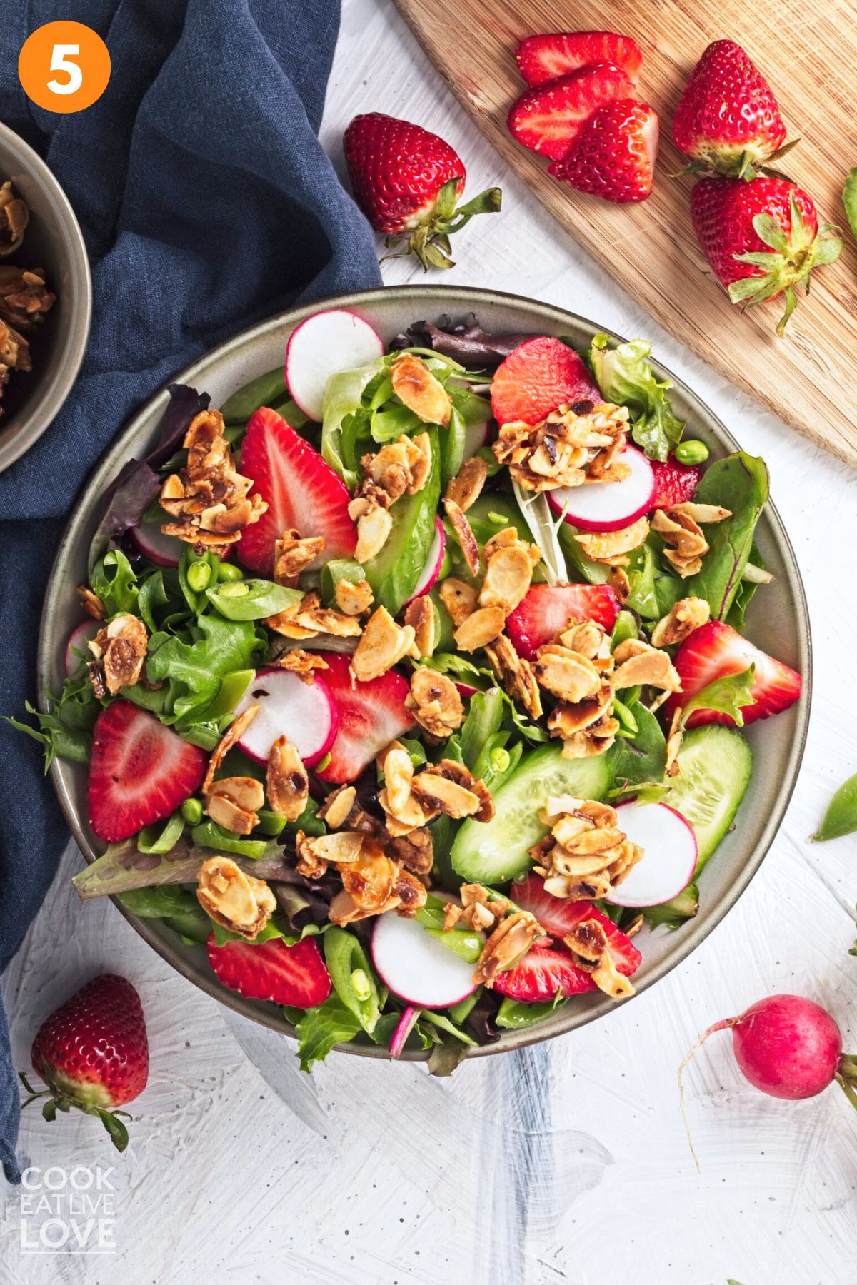 Finished summer strawberry salad in a bowl on a table. 