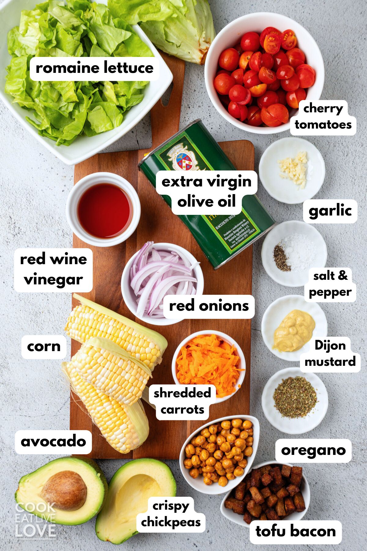 Ingredients to make a vegan cobb salad on the table with text labels on the side.