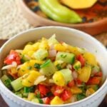 Pin for pinterest graphic with image of mango salsa and text on top.