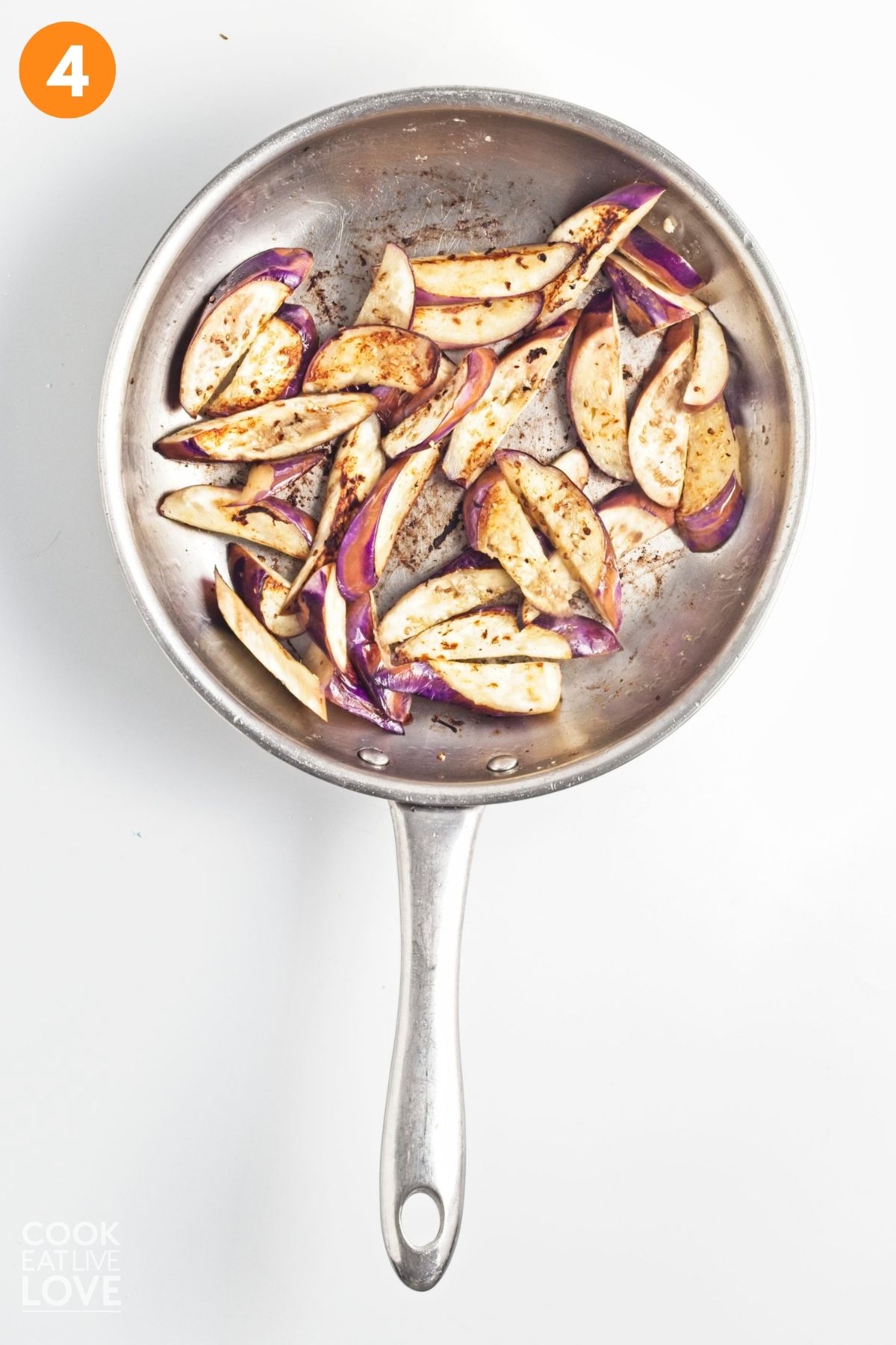 Eggplant cooking in a skillet.