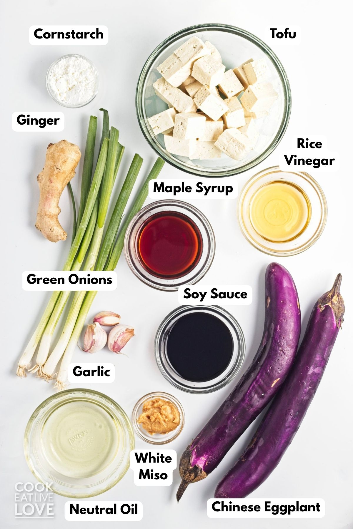 Ingredients in an eggplant and tofu recipe in bowls on a table.