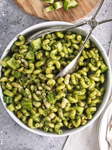 Green goddess pasta salad in a bowl with a white napkin to the side.