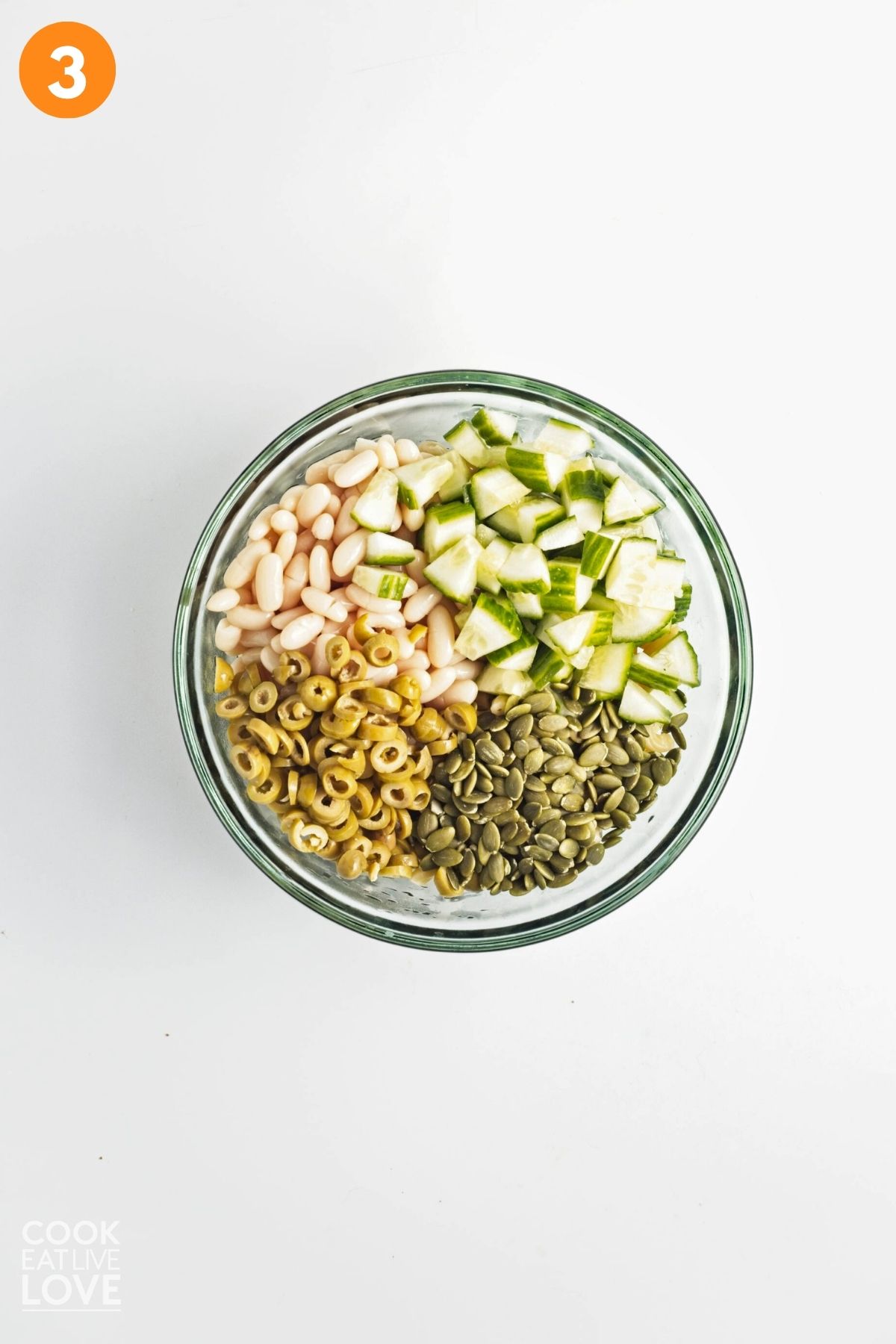 Chopped ingredients for pasta salad added on top of the pasta.