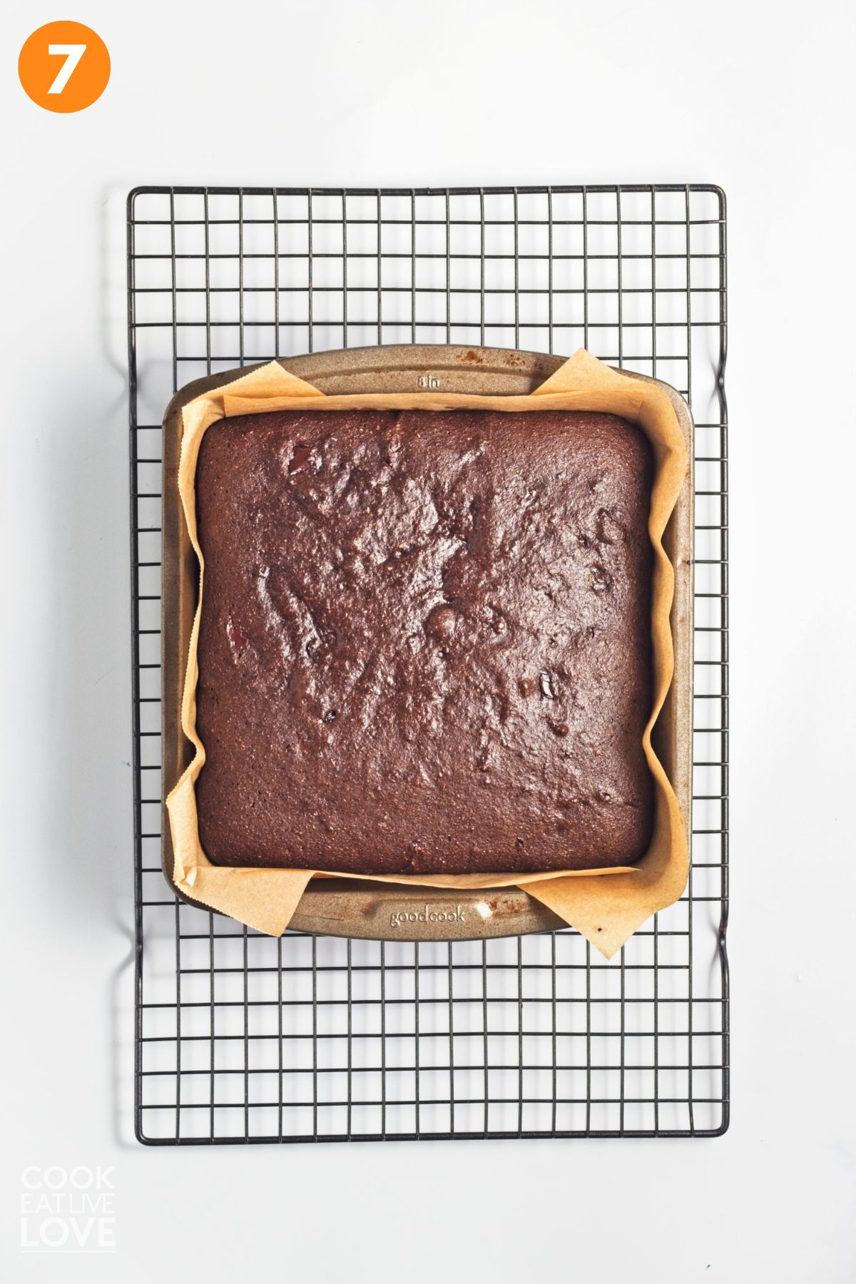 Baked zucchini brownies on a wire rack cooling.