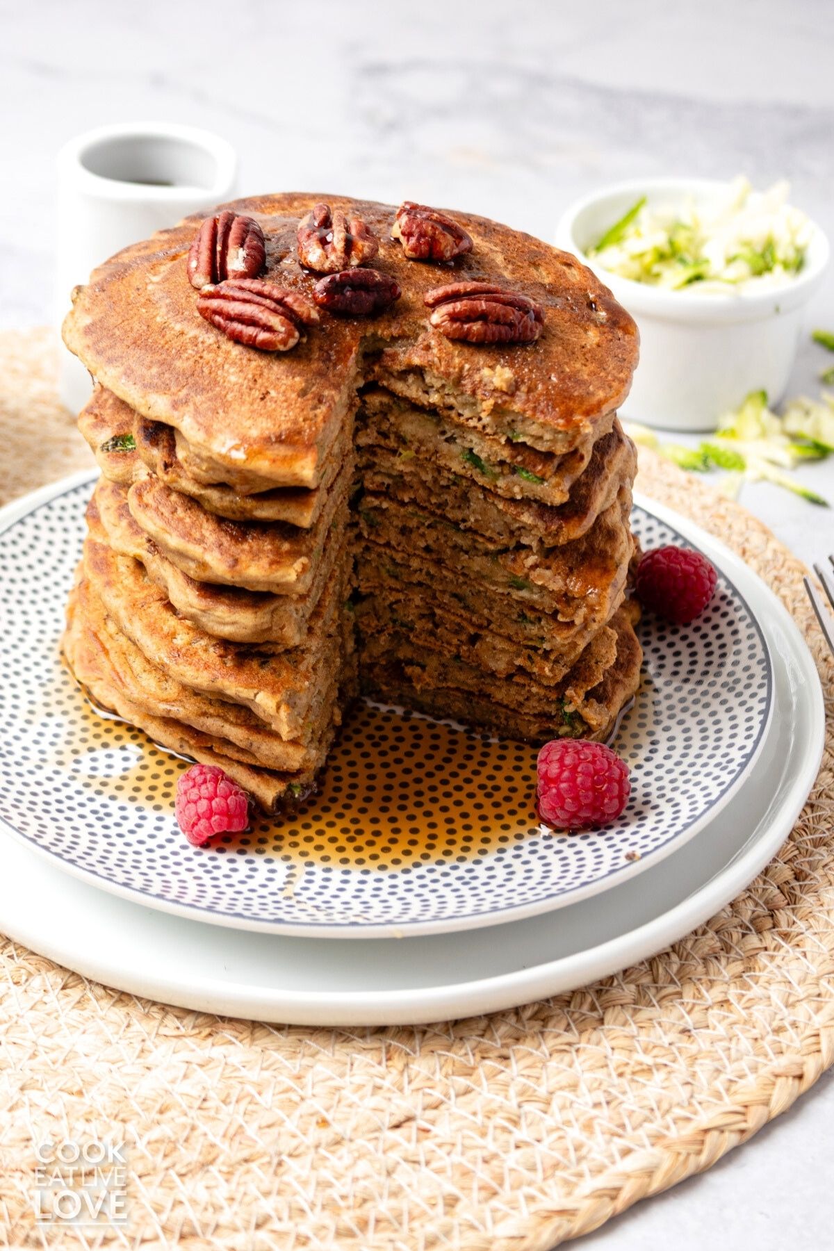 A stack of zucchini pancakes with a section cut out to show the inside.