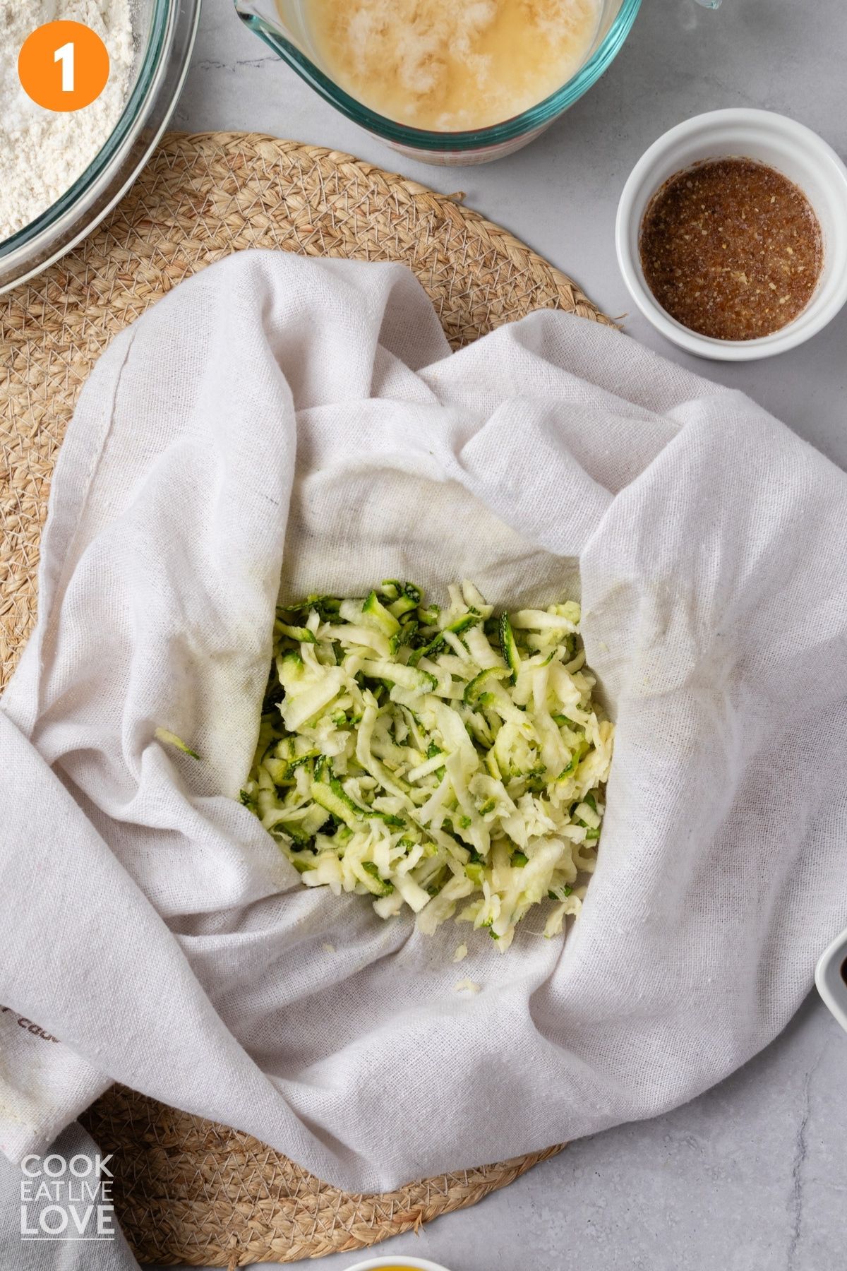 Zucchini in a towel to squeeze out excess water.
