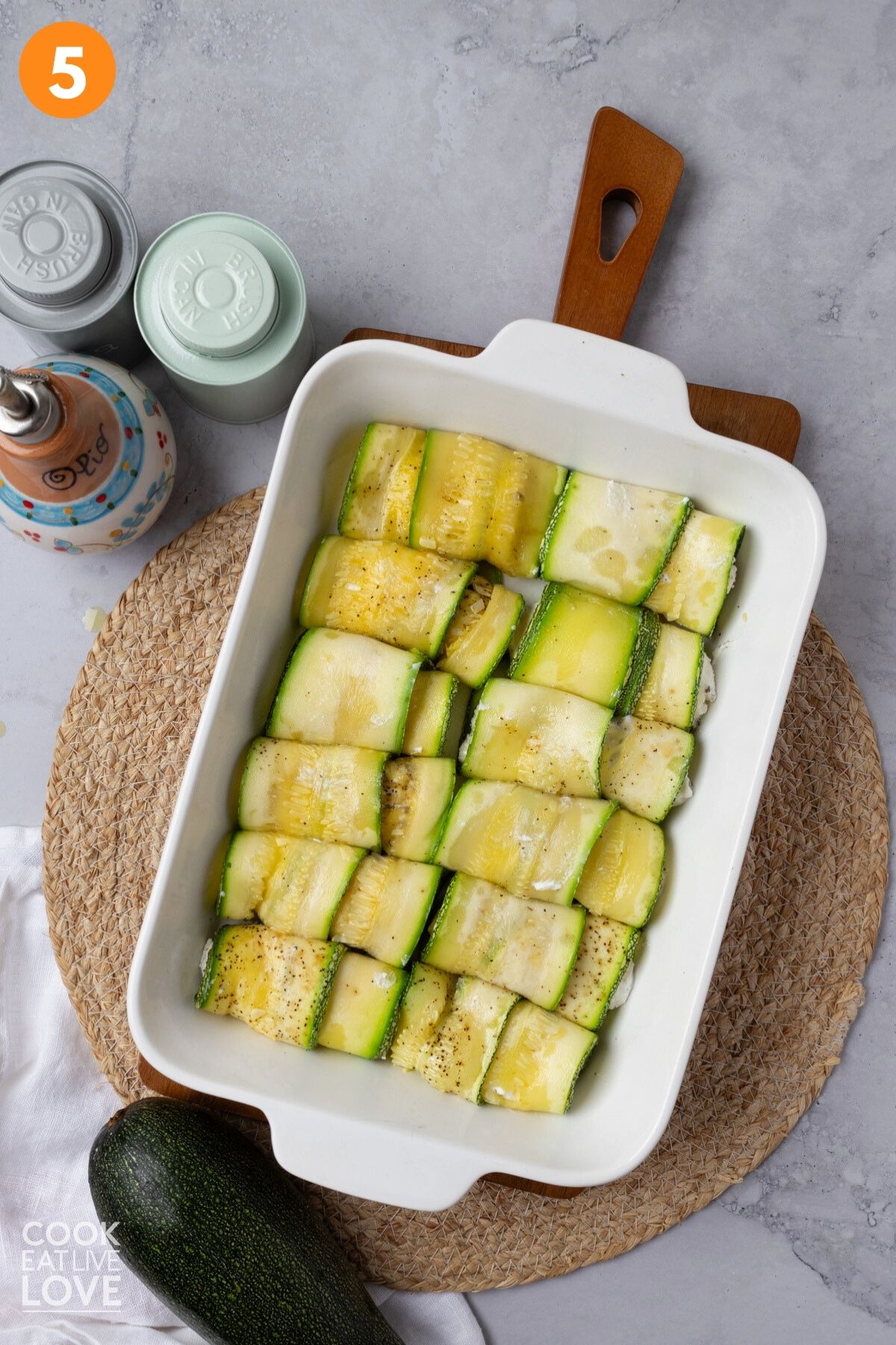 Zucchini rolled up in a baking dish.