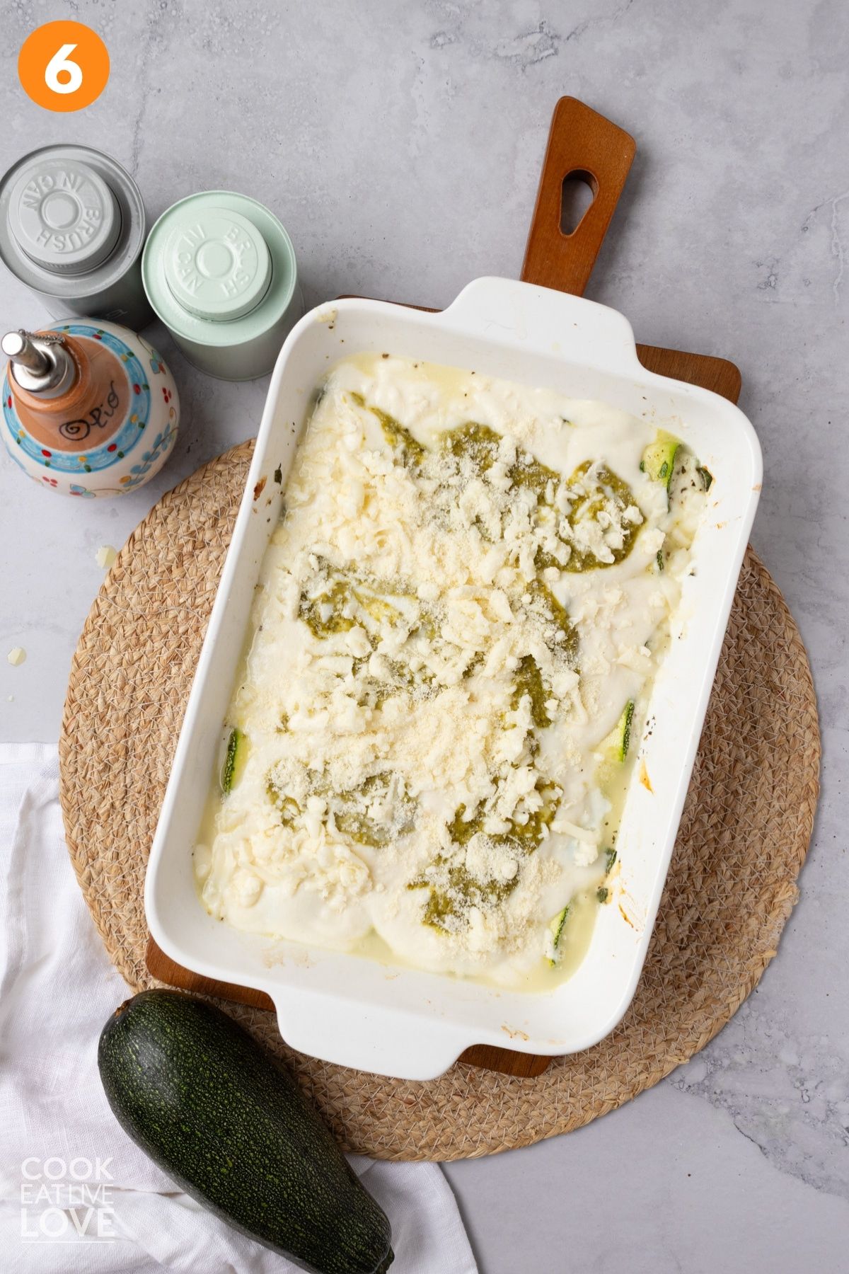 Alfredo, pesto, and cheese added on top of the zucchini rollatini.