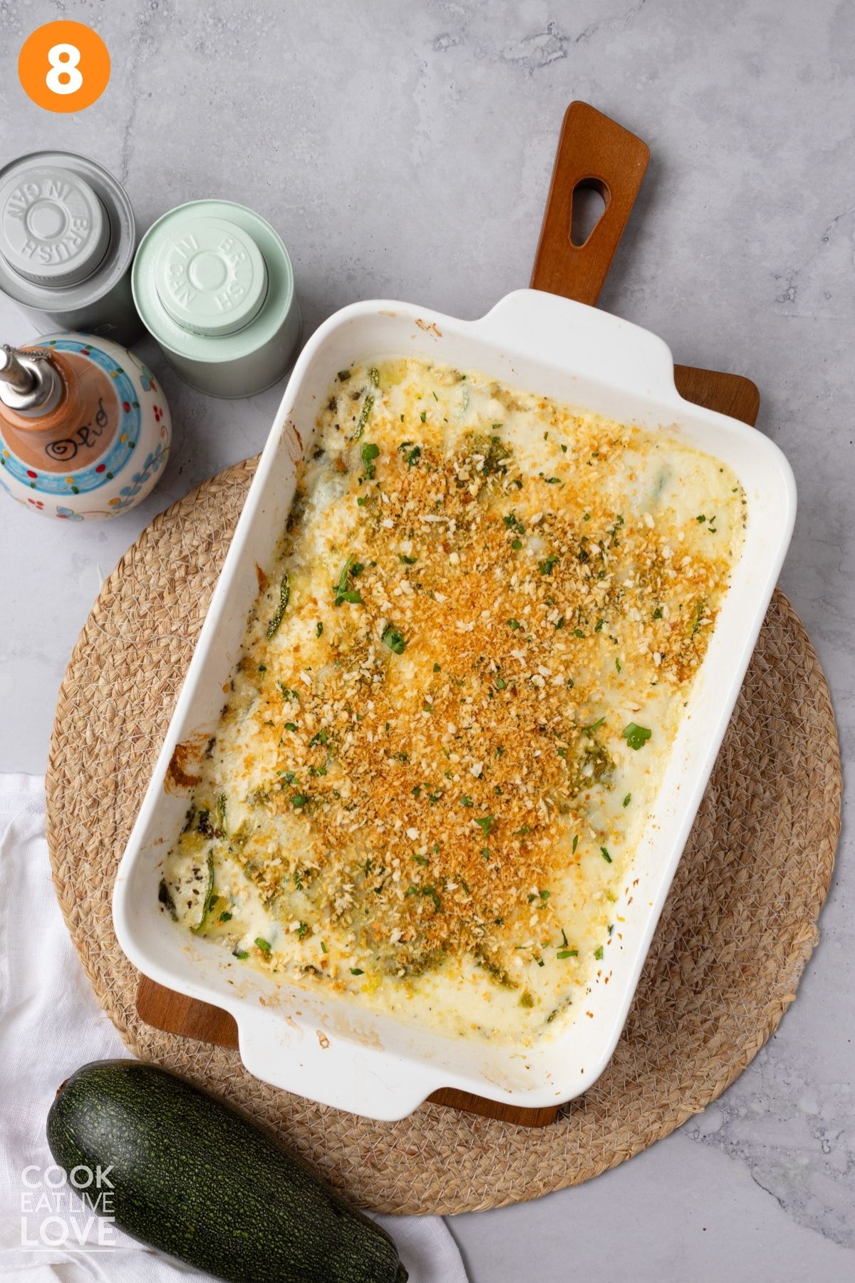 Zucchini rolls in a baking dish topped with panko.