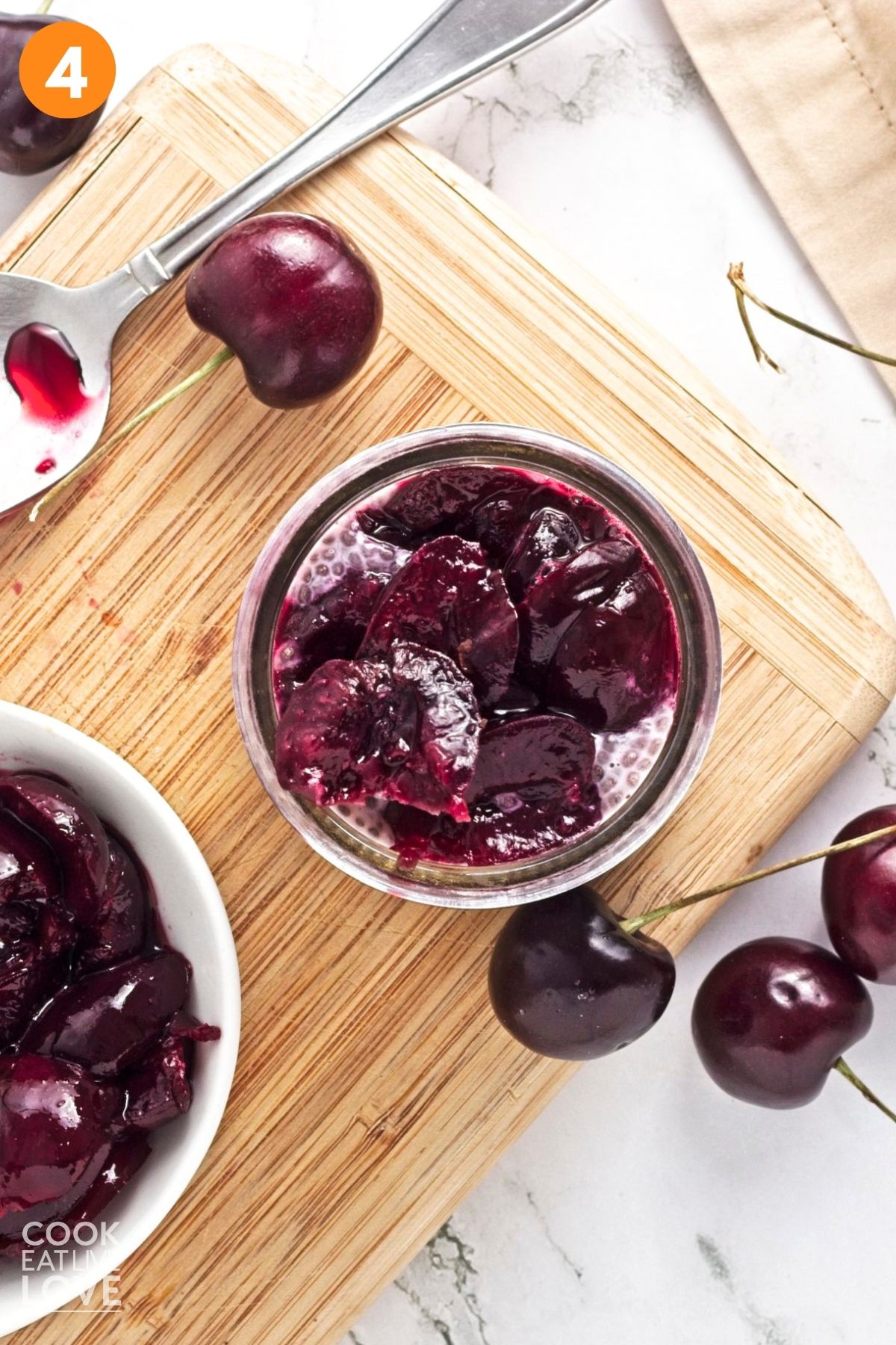 Chia mixture transferred to jars and topped with cooked cherries.