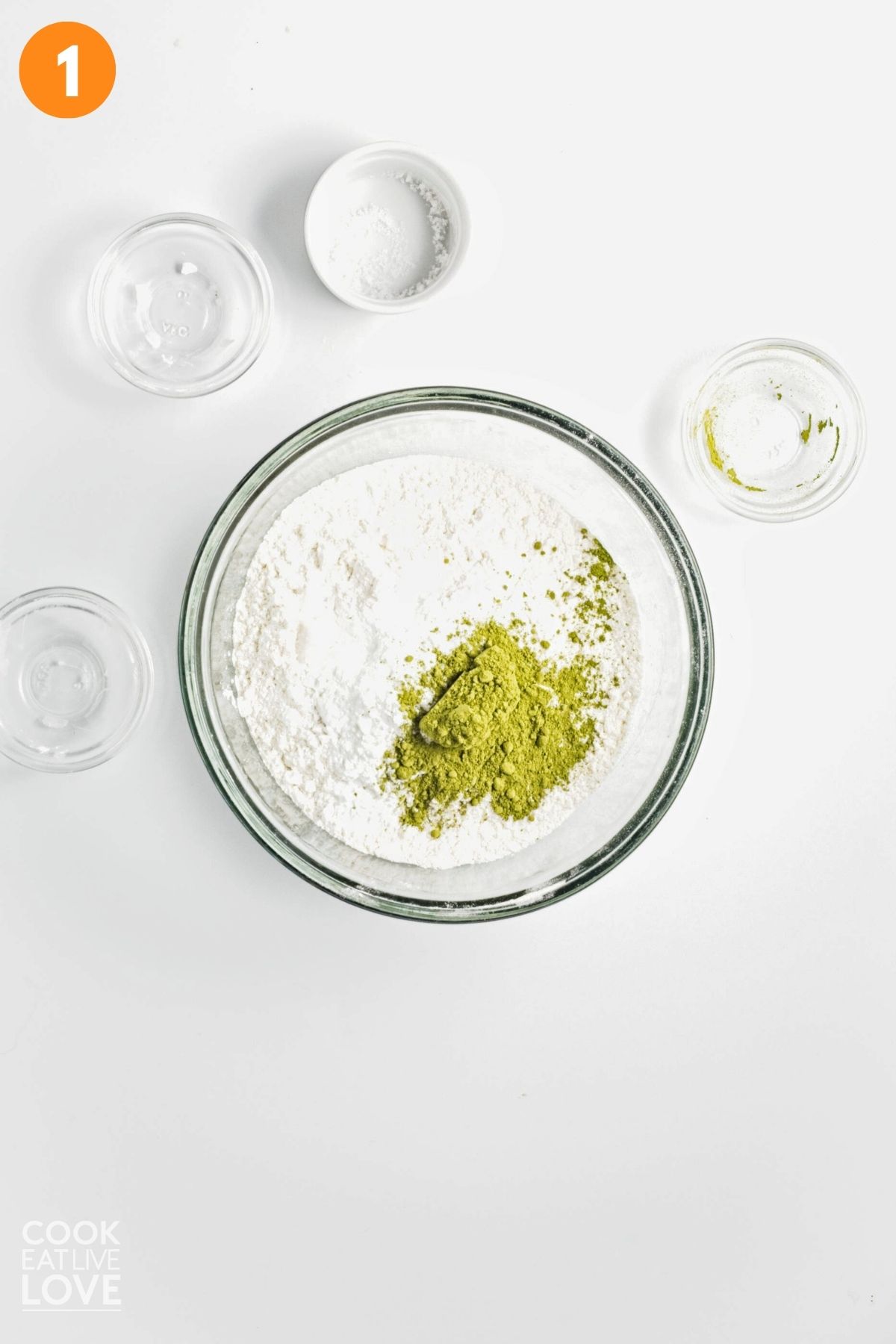 Dry ingredients to make matcha tea muffins added to a bowl.