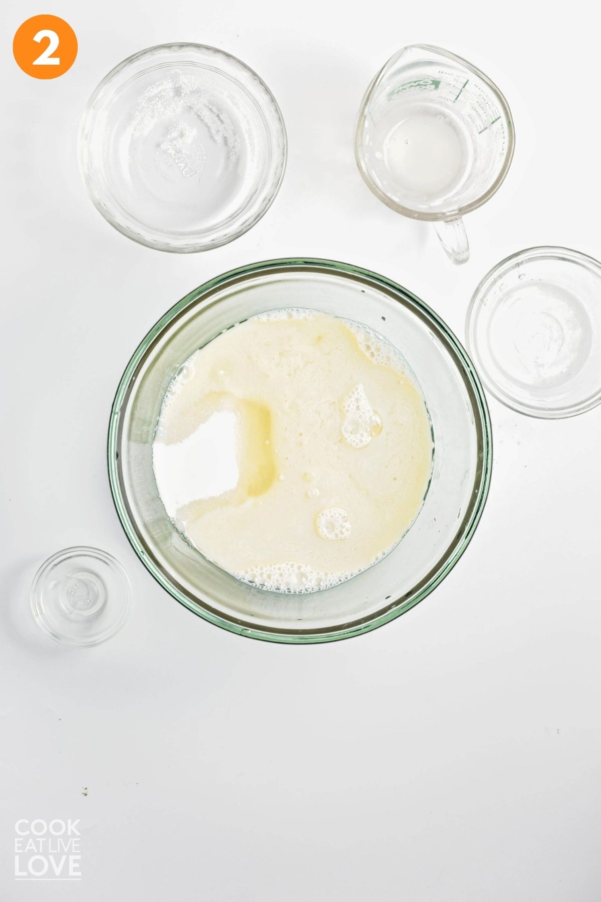 Wet ingredients added to a mixing bowl.