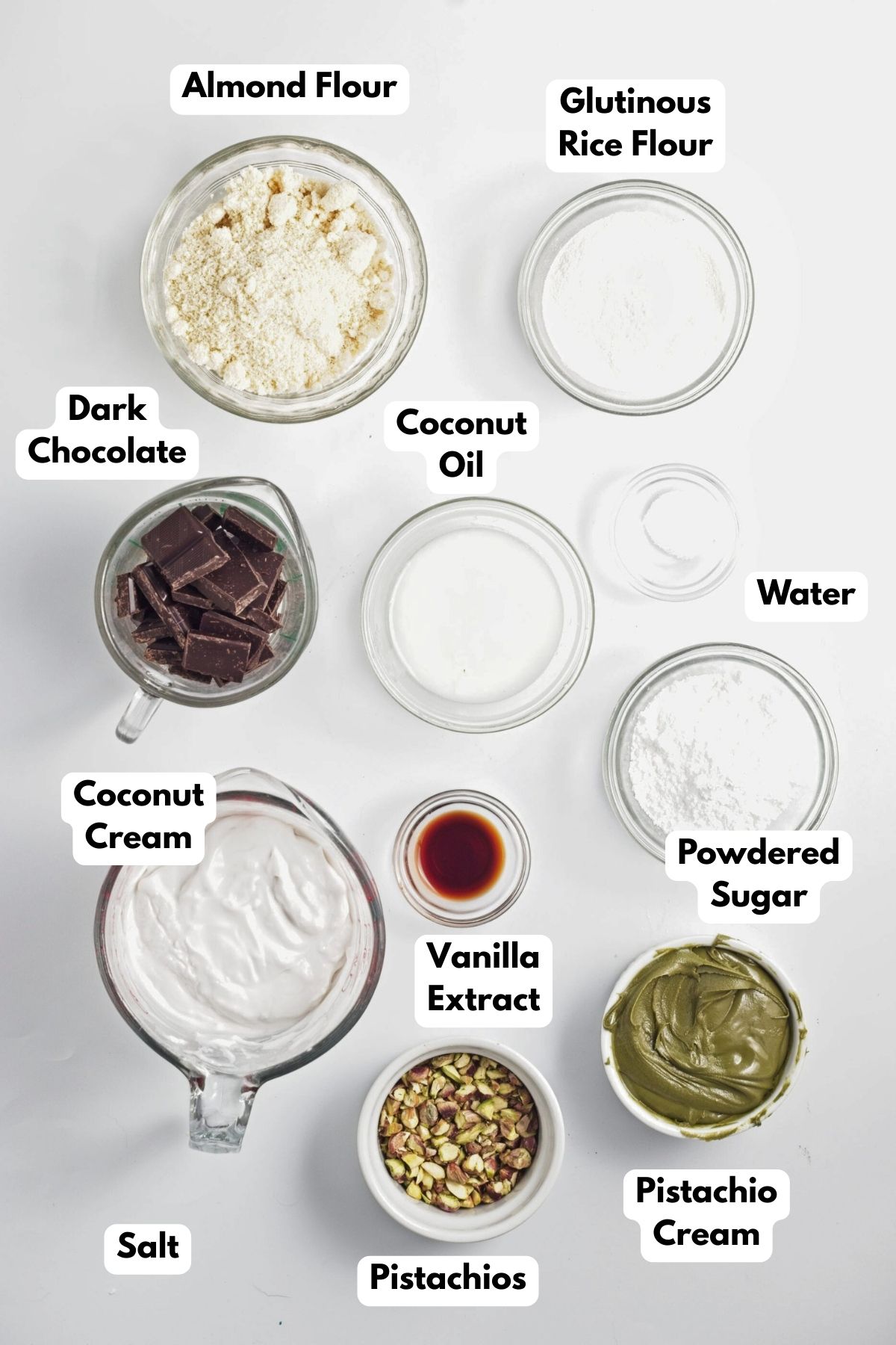 Ingredients to make chocolate pistachio bars on the table with labels on them.