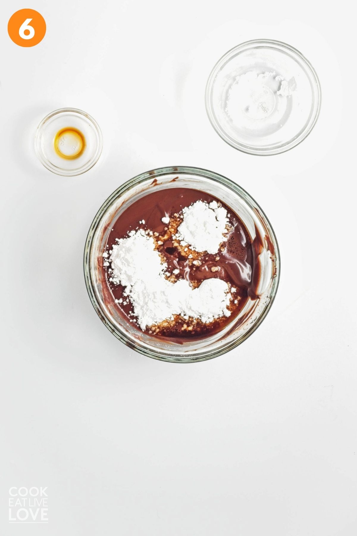 Adding the powdered sugar to the melted chocolate mixture. 