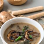 Pinterest graphic with bowl of vegan mushroom soup and text on top.