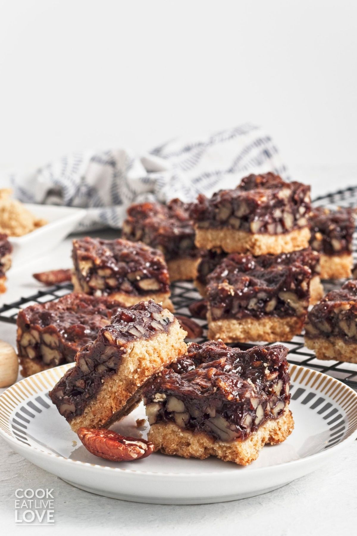 Two vegan pecan pie bars with one leaning on the other. 