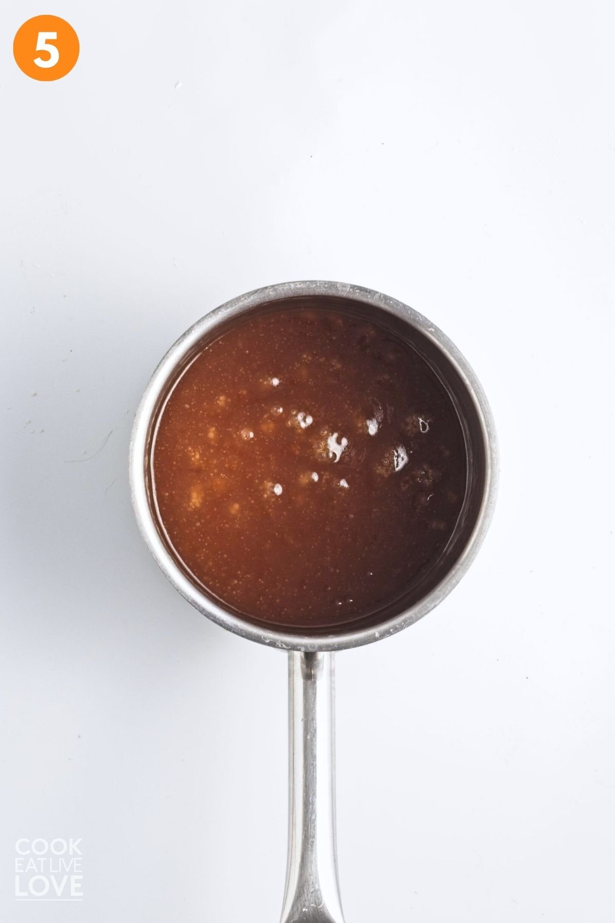 Caramel sauce for pecan bar filling cooked in a saucepan.