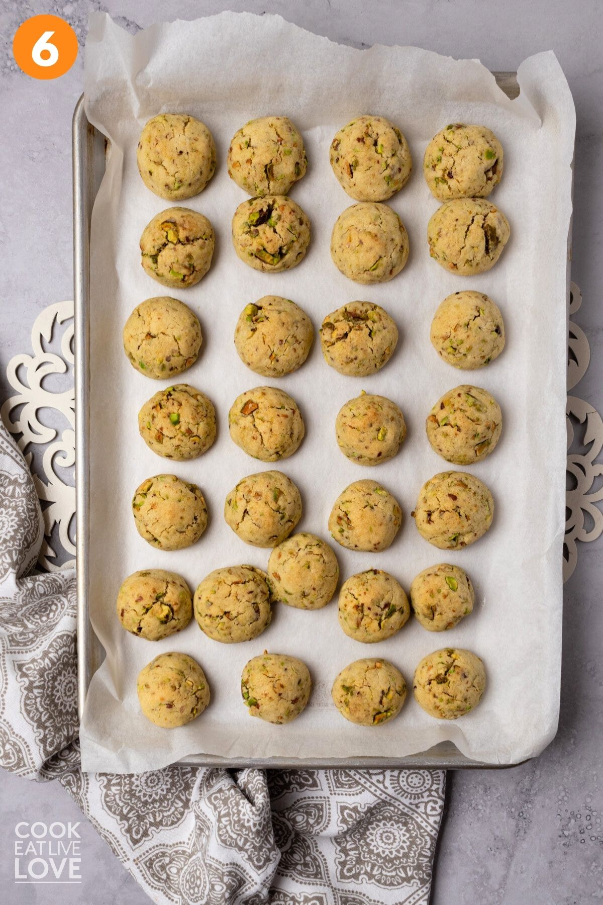 Baked pistachio cookies on a baking sheet. 