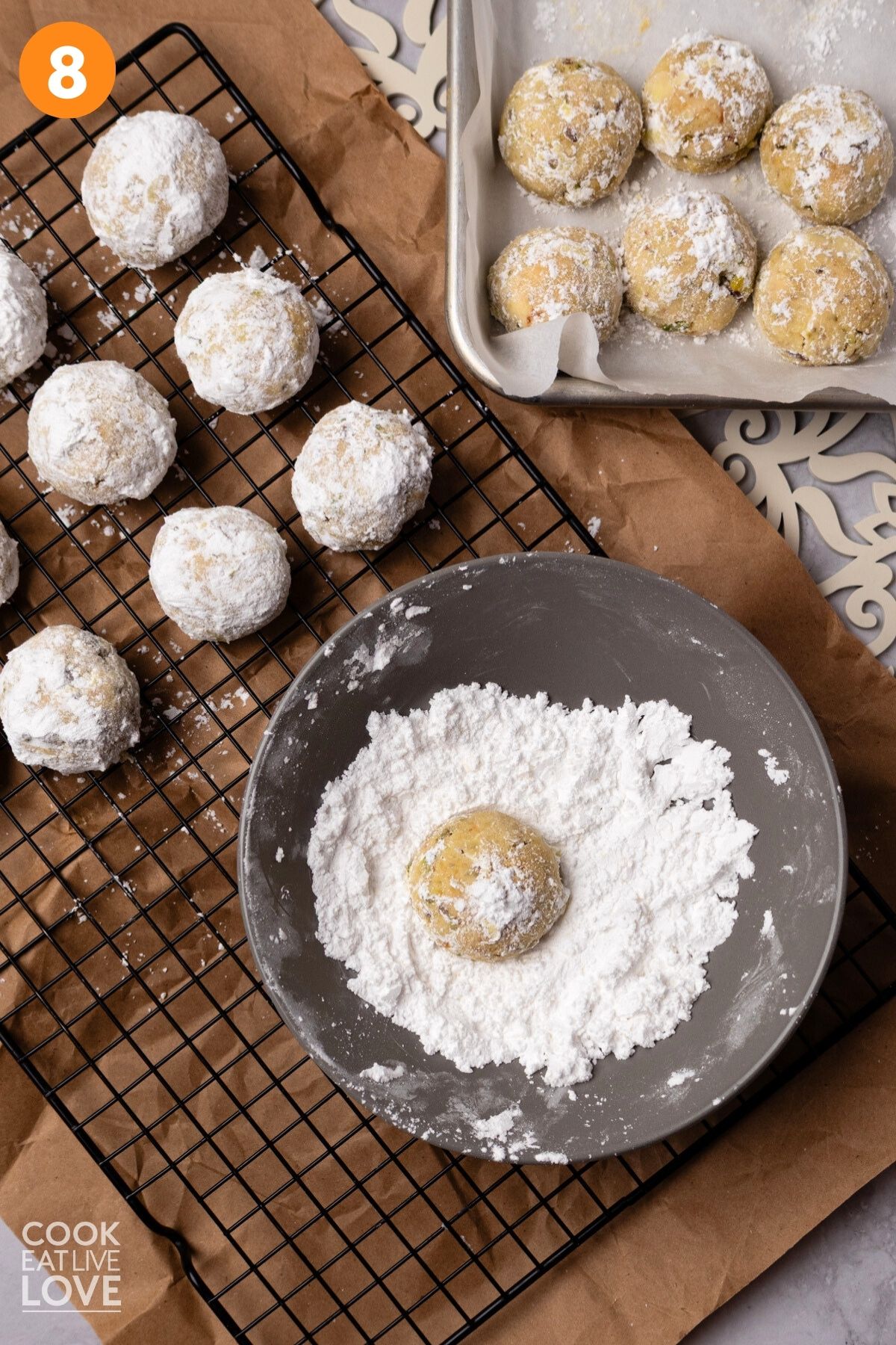 Final roll of cookies in powdered sugar. 
