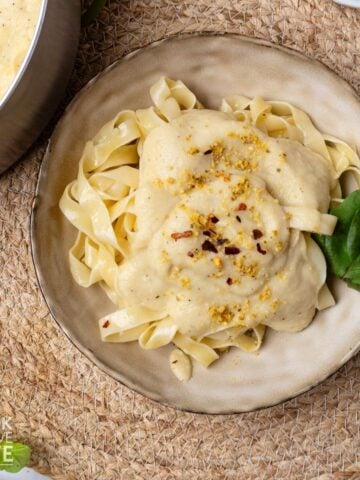 Vegan alfredo sauce served with fettuccine on a plate.