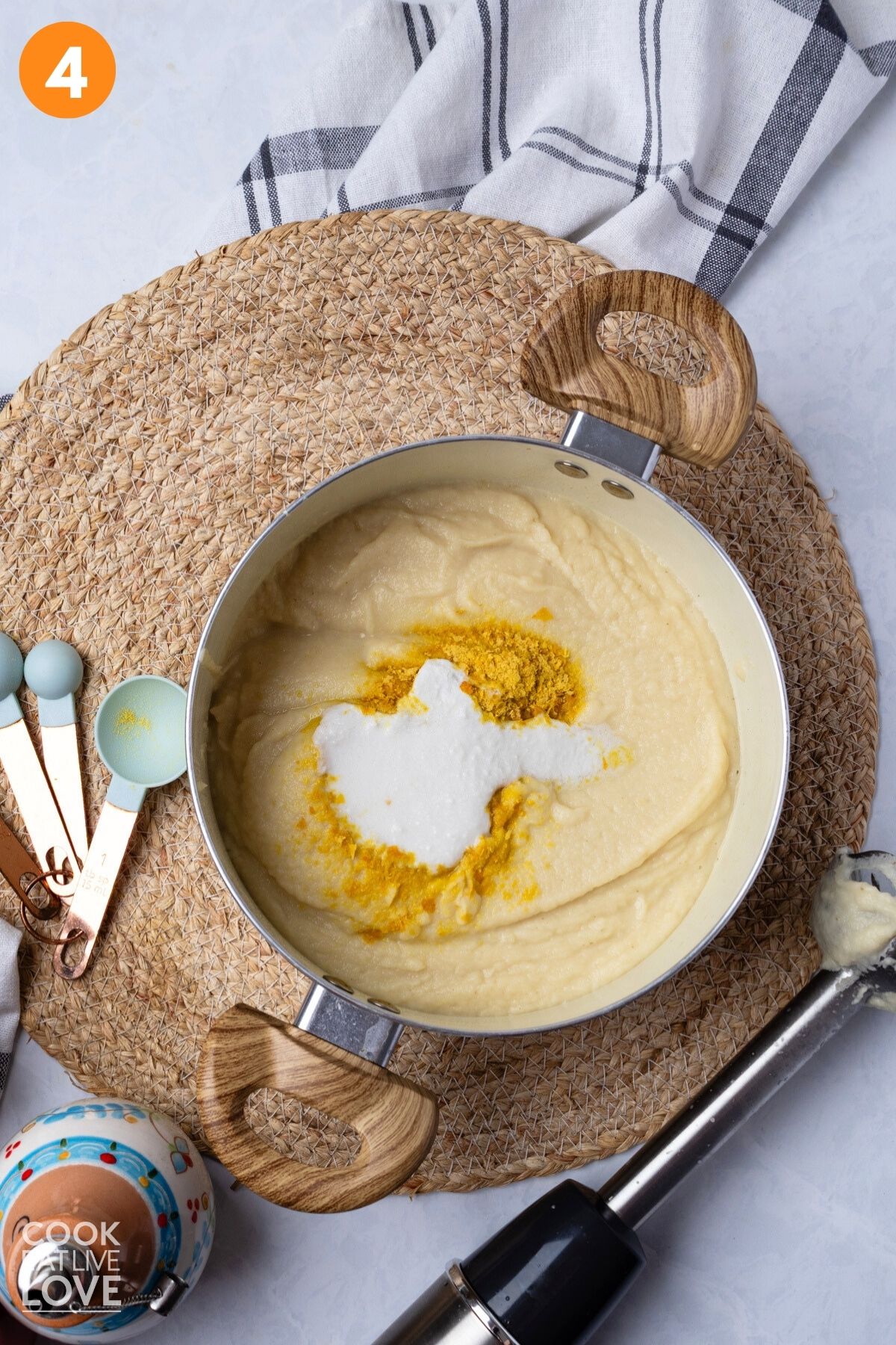 Nutritional yeast and coconut milk are added to the pot.