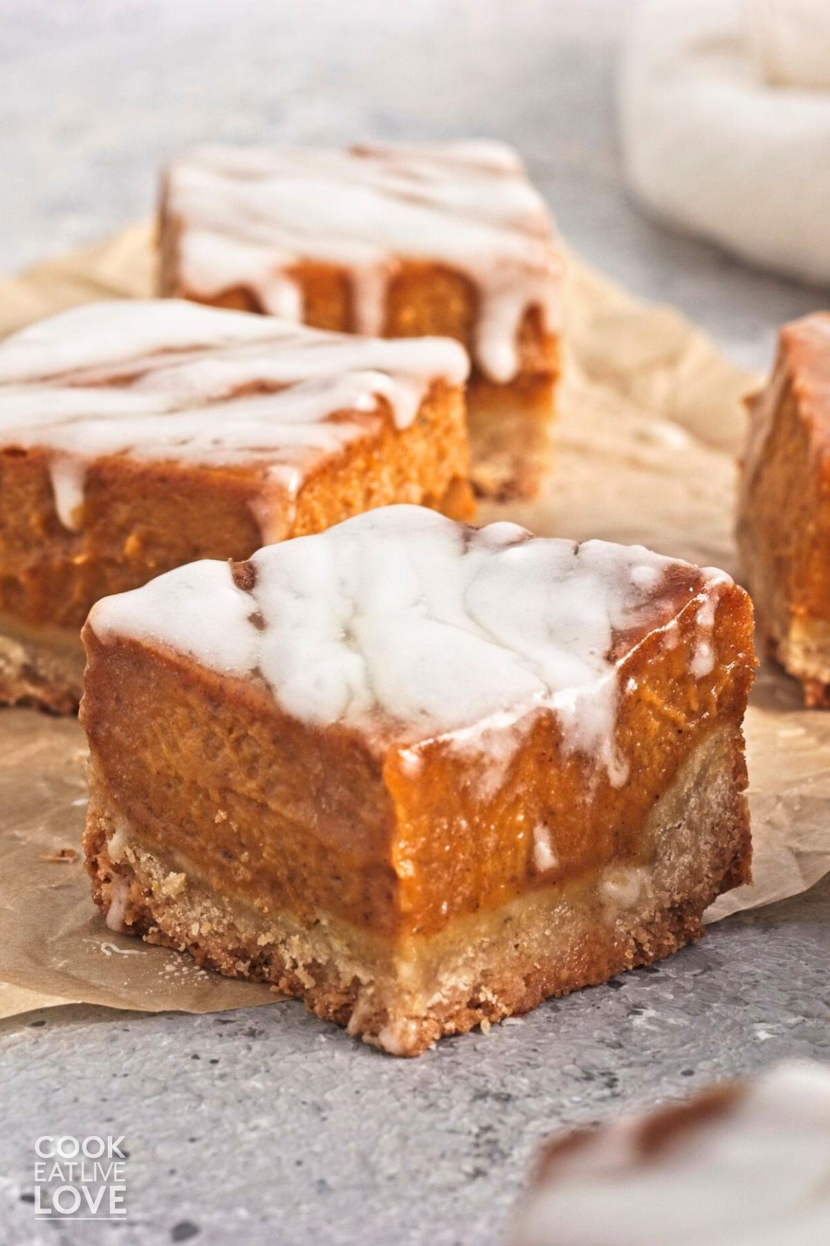 Vegan pumpkin bars on a wooden cutting board.