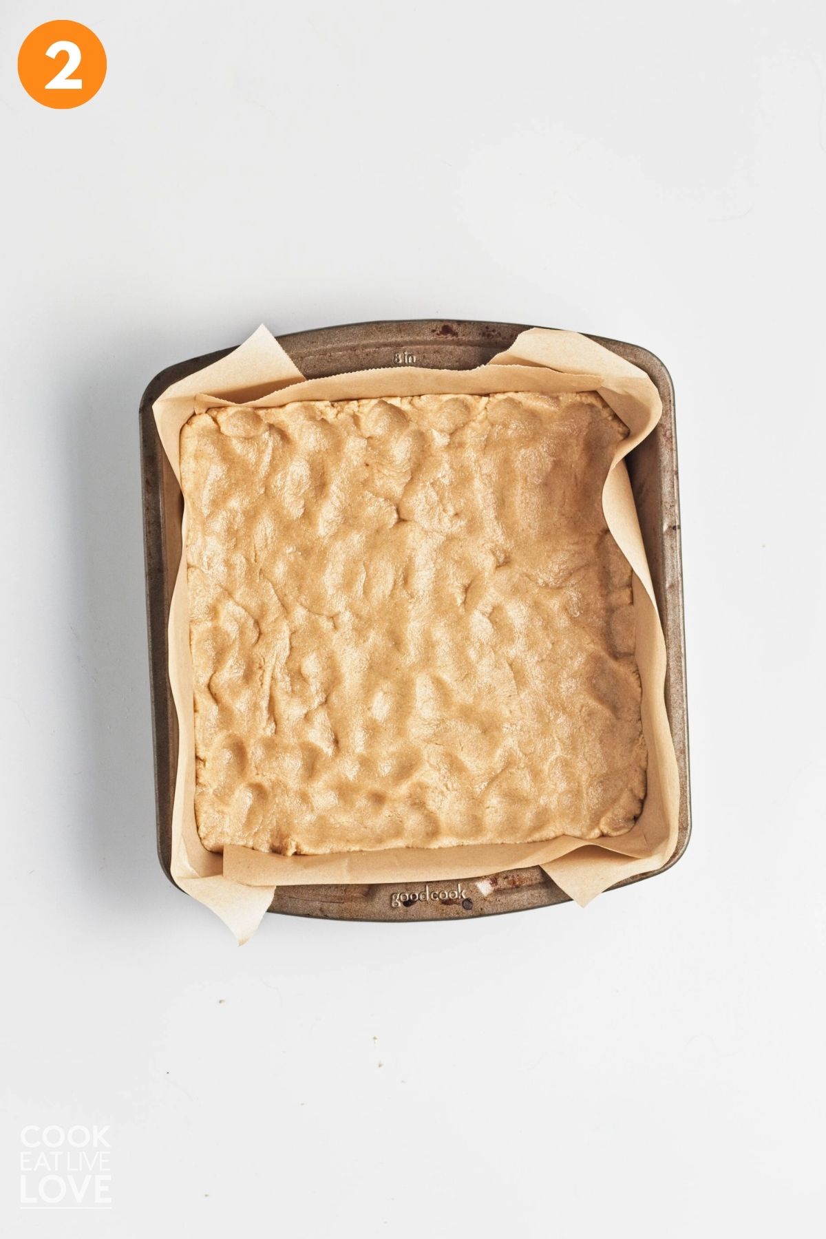 Crust pressed into a parchment lined square baking pan.