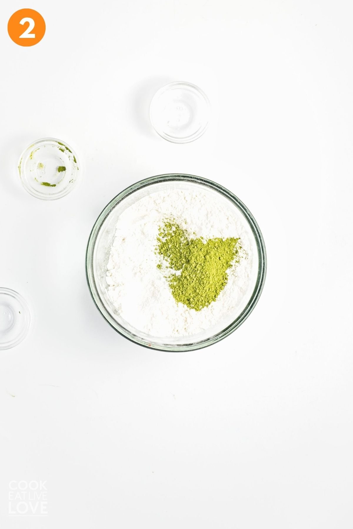 Flour, matcha, and other dry ingredients in a mixing bowl.