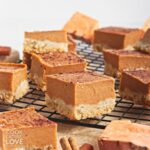 Sweet potato bars cut into squares and laid out on a wire rack.