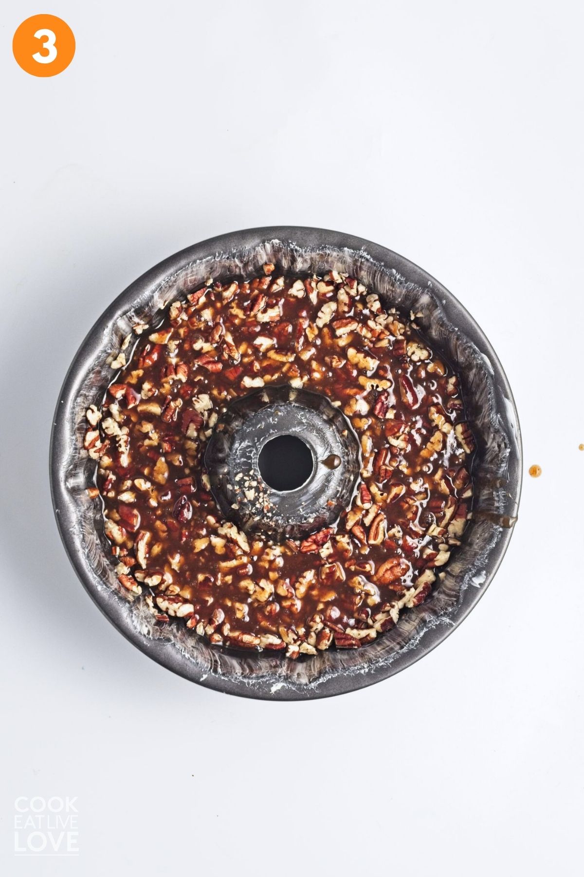 Pecan mixture poured into a bundt pan.