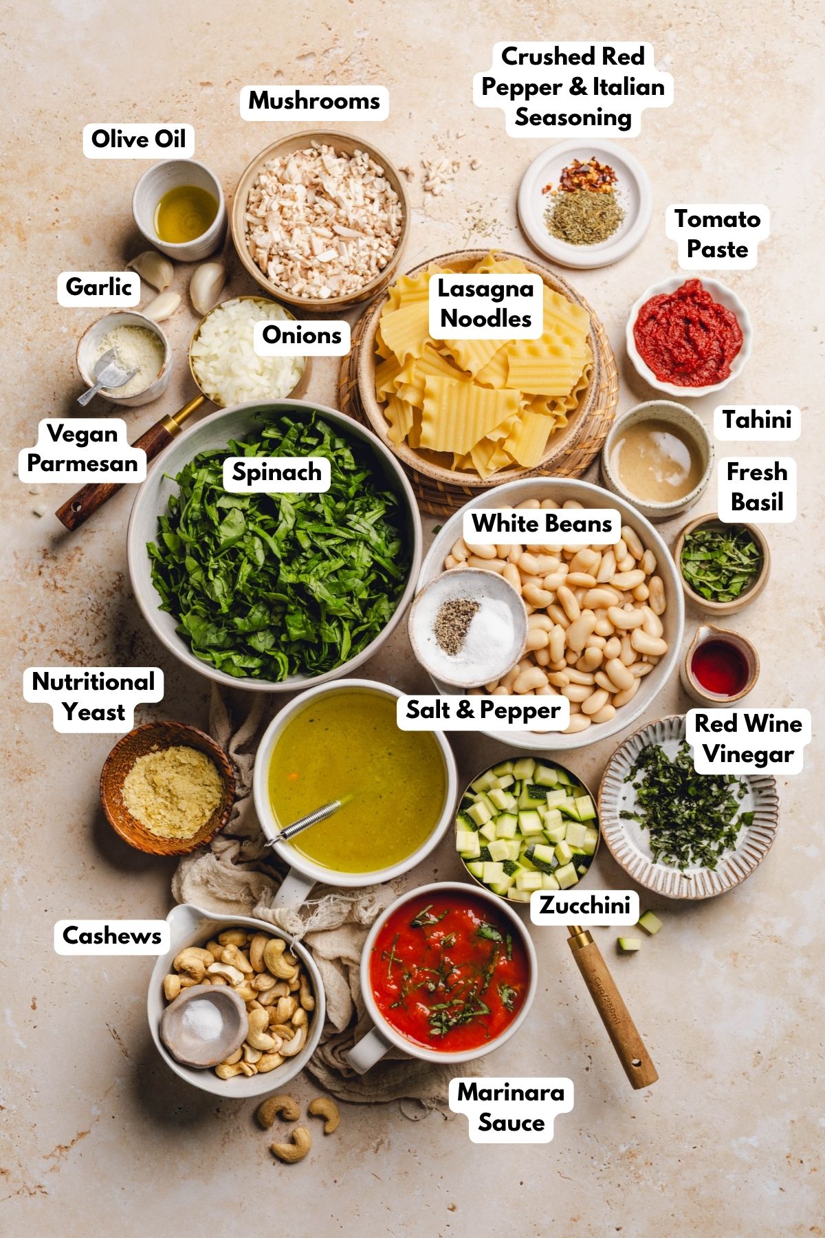 Ingredients to make vegan lasagna soup in bowls on a table. 