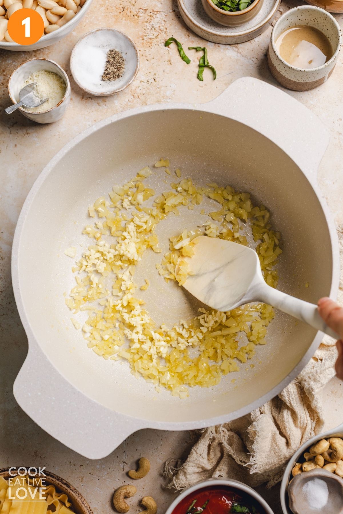 Cooking the onion and garlic in a pot.