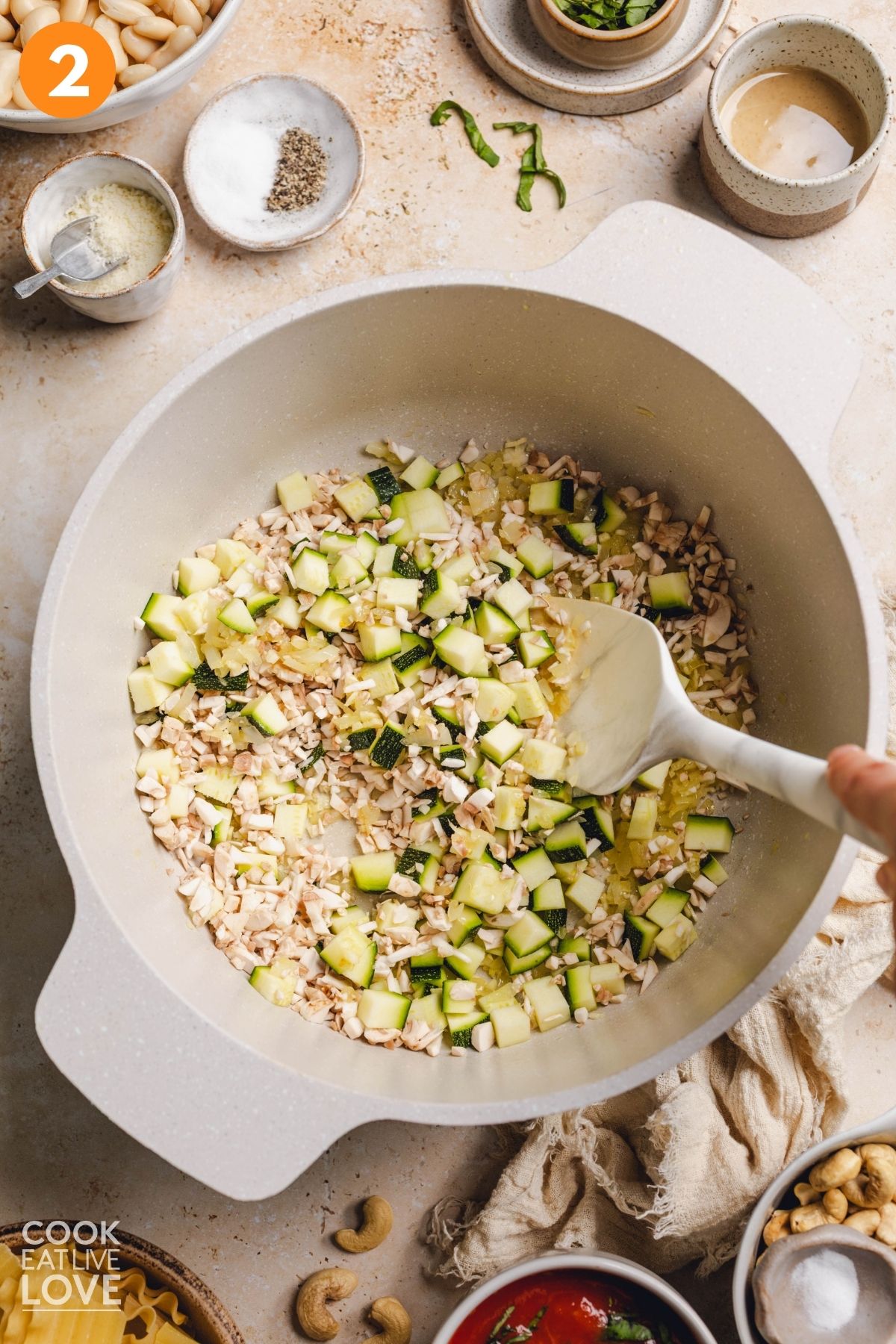 Zucchini and mushrooms added to the pot to cook. 