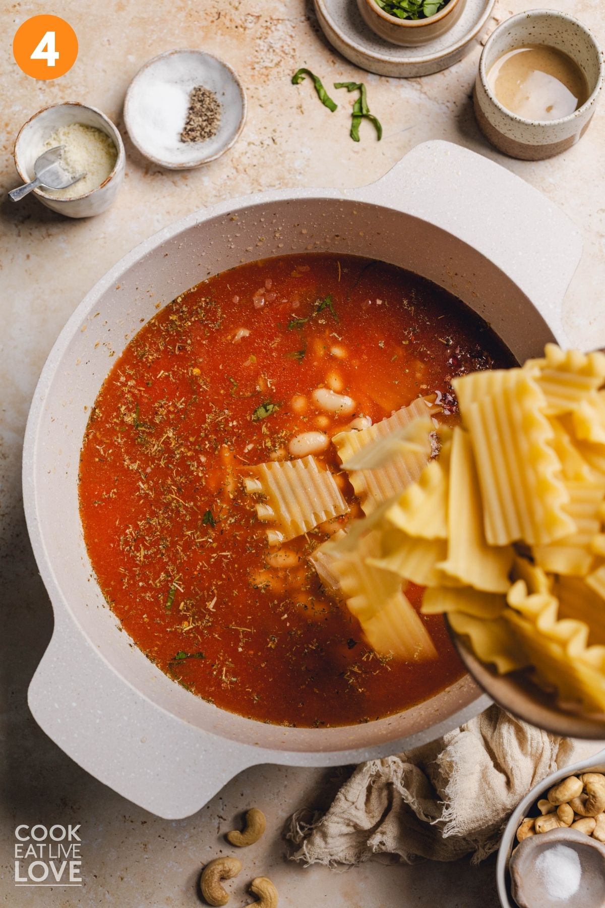 Adding the lasagna noodles to the pot. 