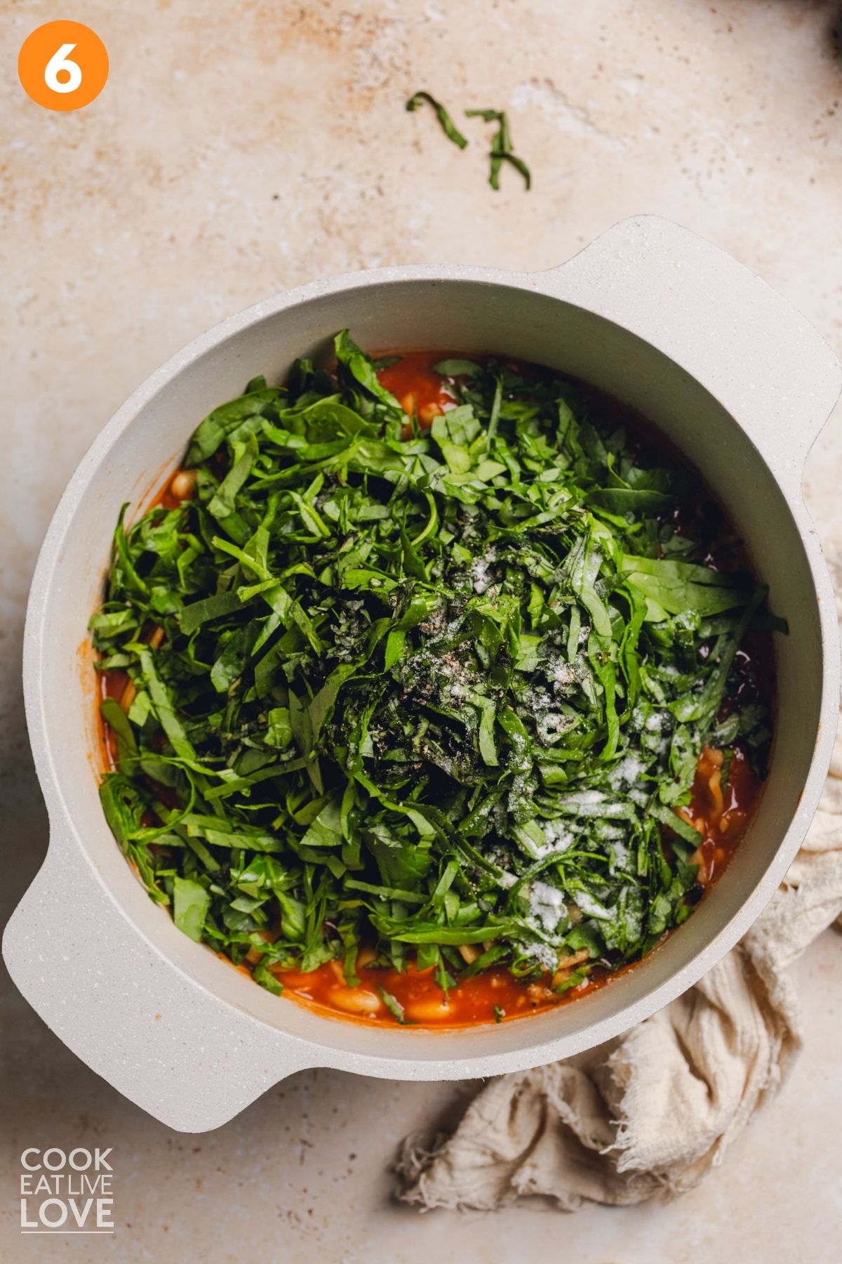 Spinach added to the pot of soup.