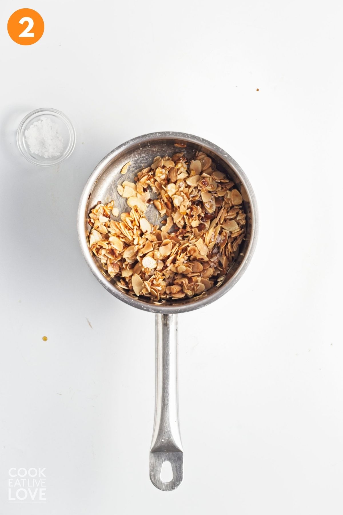 Almonds added to the sugar mixture in the sauce pan. 