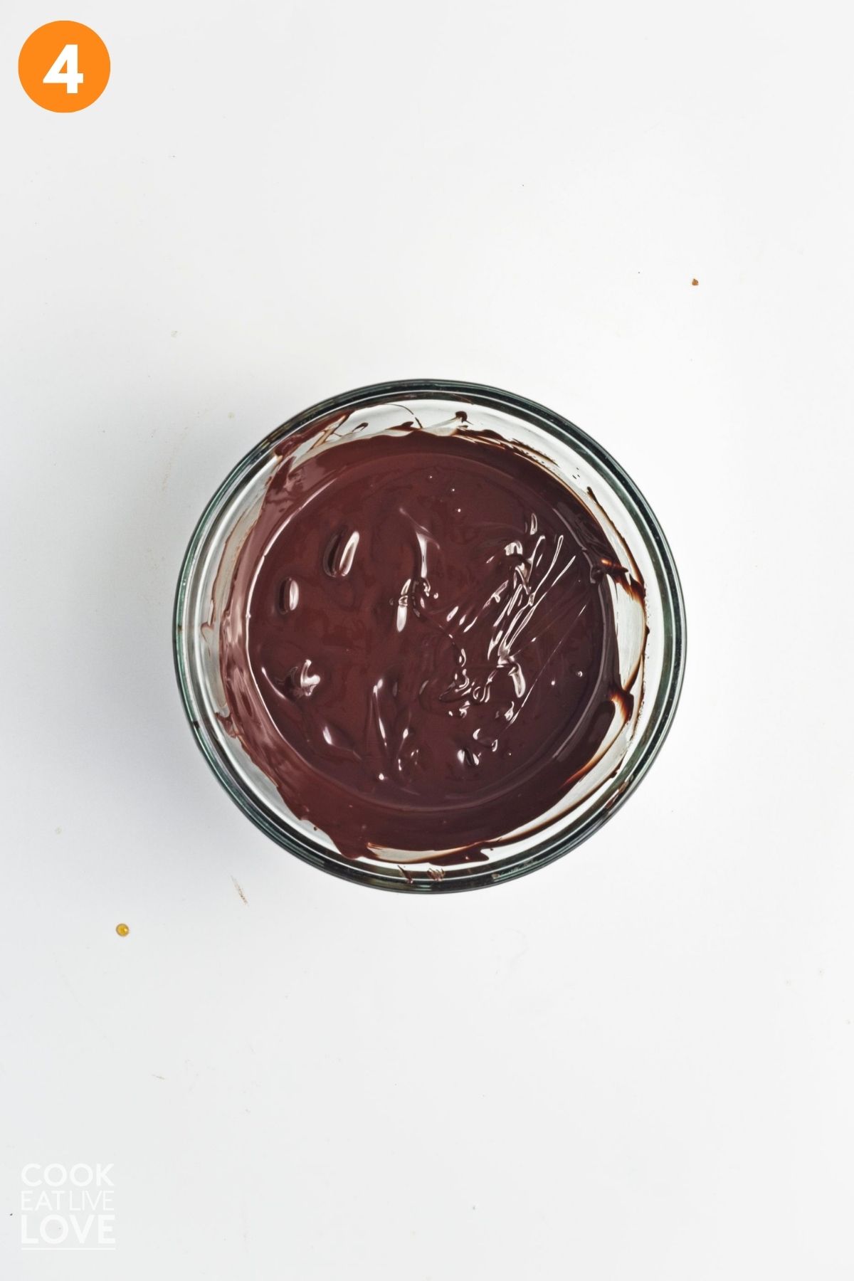 Chocolate melted in a glass bowl. 