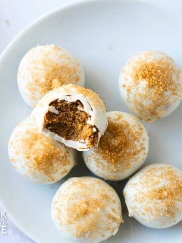 Gingerbread truffles on a plate with a bite taken from the one on top.
